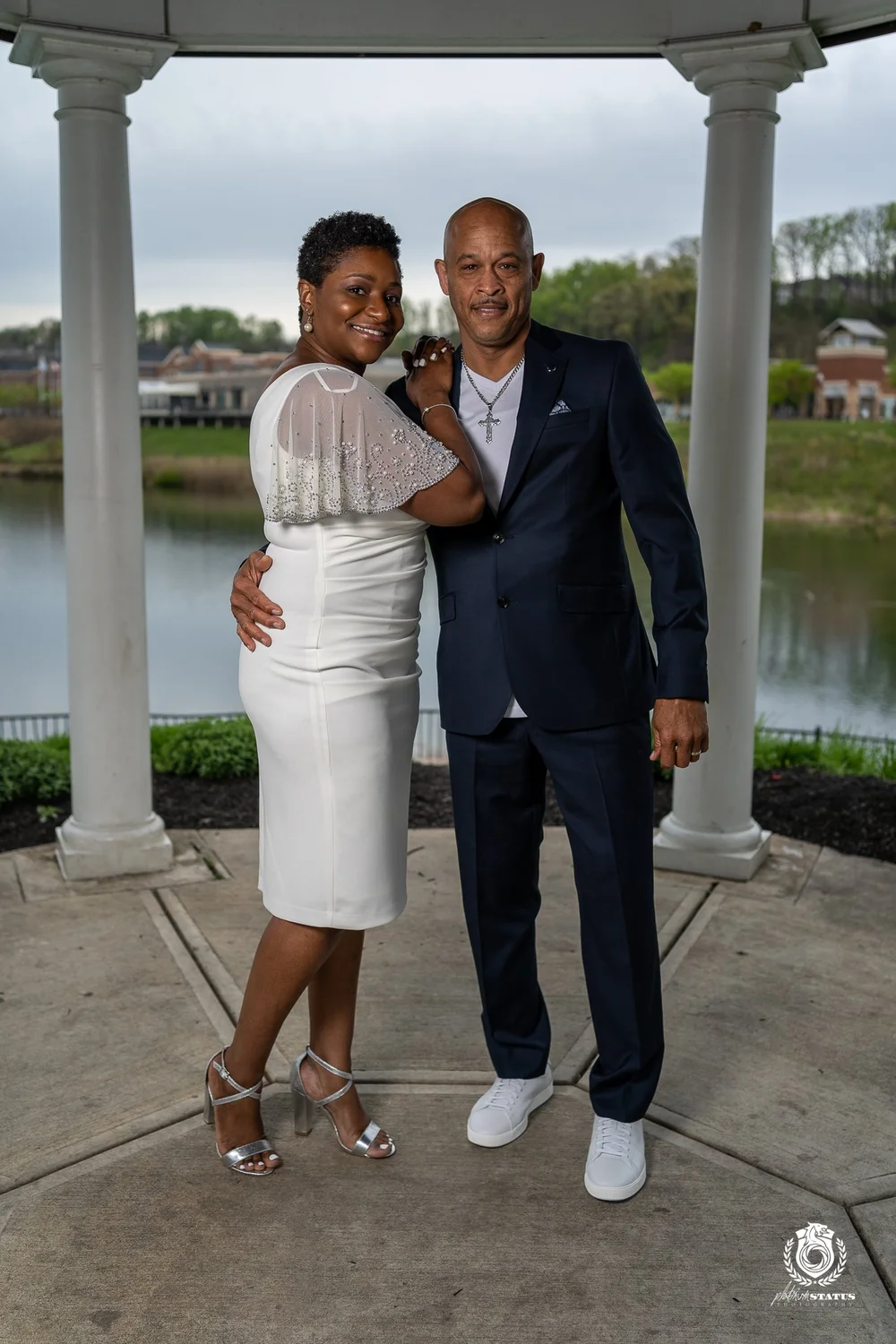 Bride and groom embrace at a waterfront wedding venue
