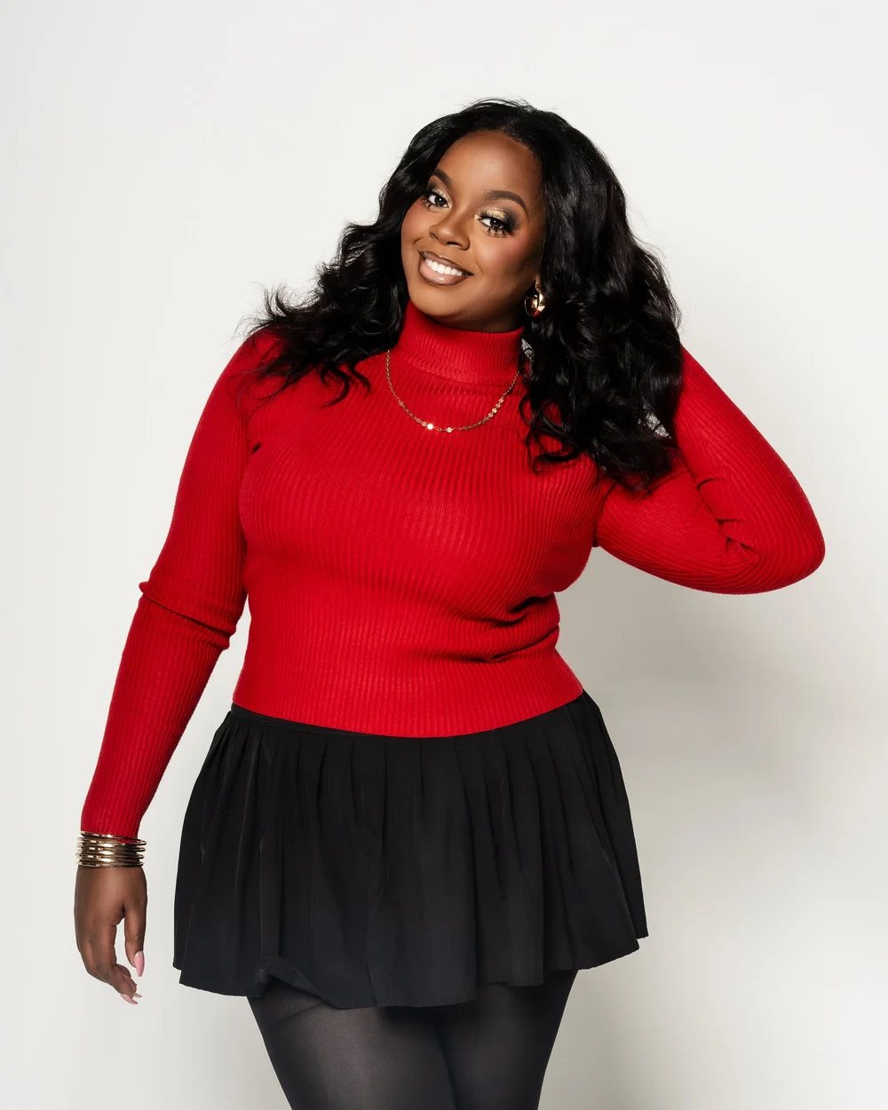 Studio portrait in a red top on a dark backdrop