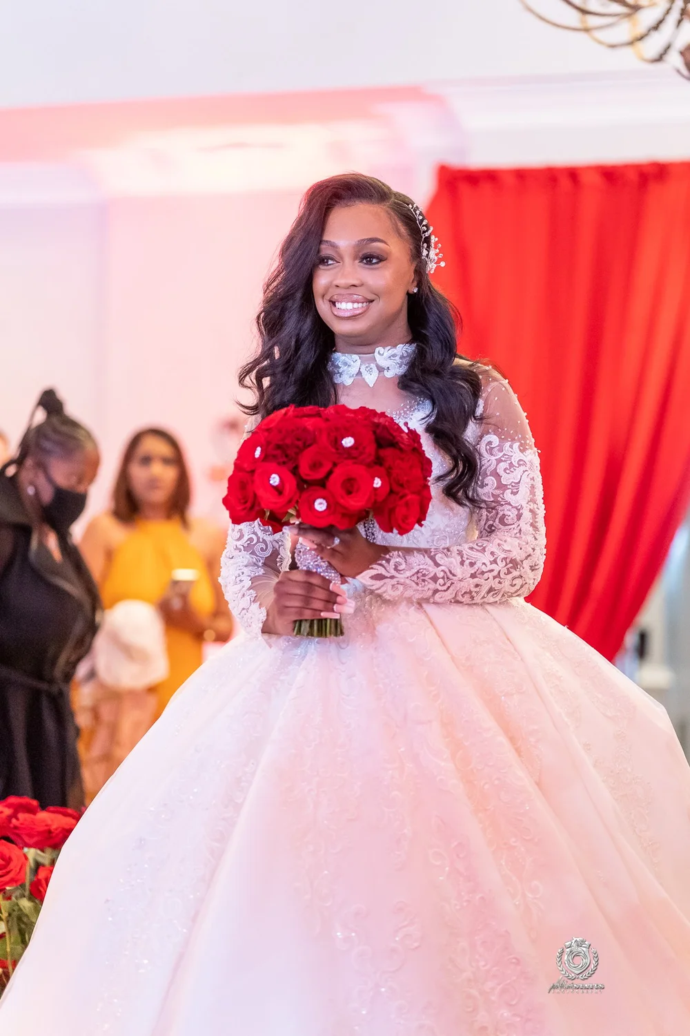 Bride in a ballgown at a red-and-pink themed wedding reception