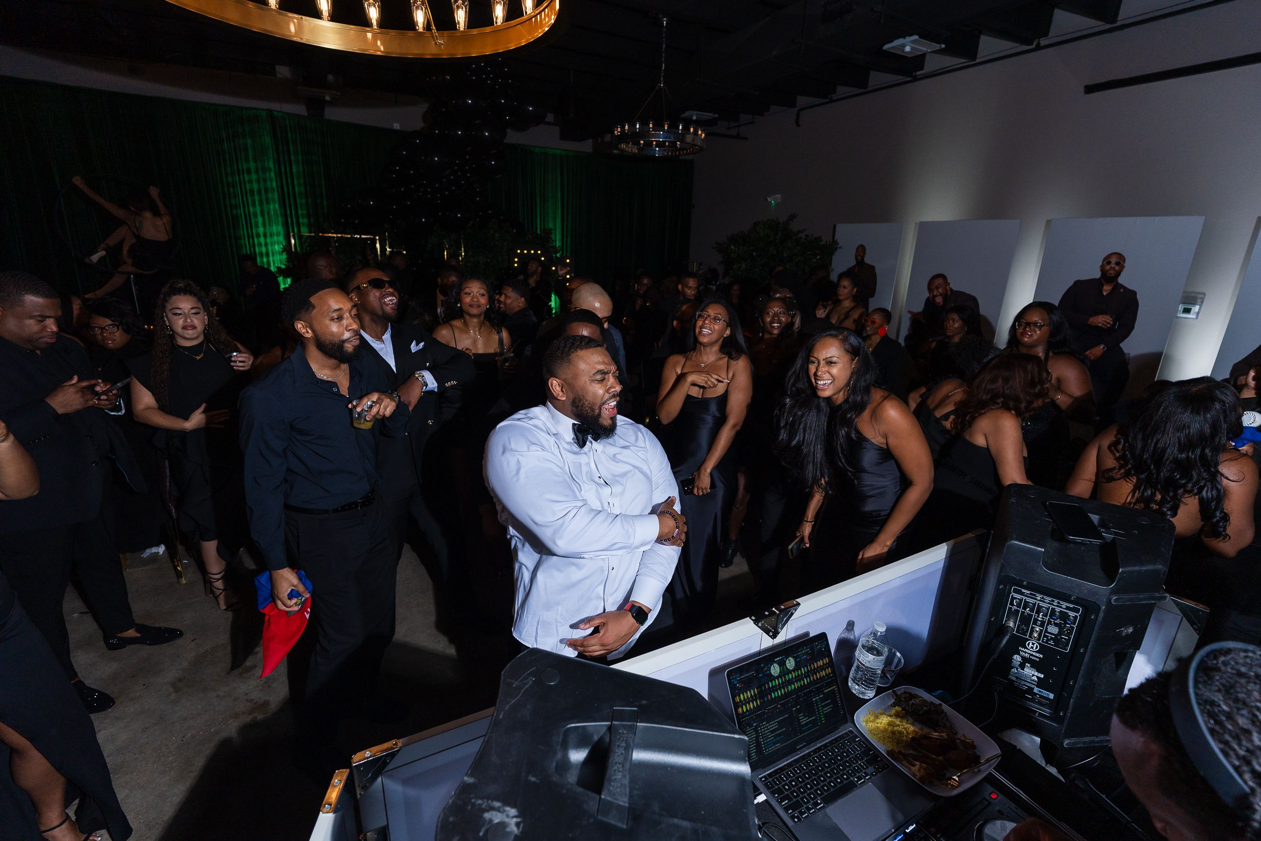 Guests dancing near the DJ booth at a Baltimore event