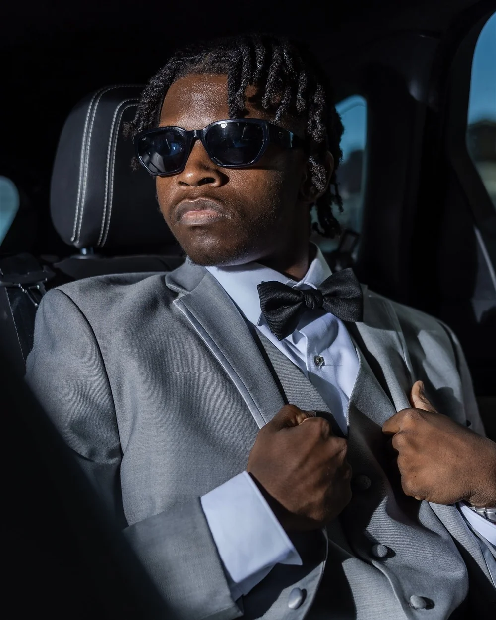 Prom portrait in a grey suit and bow tie