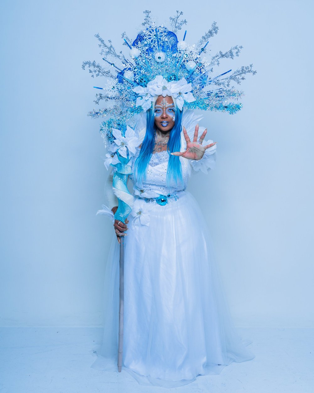 Studio portrait in a blue gown on a bright backdrop