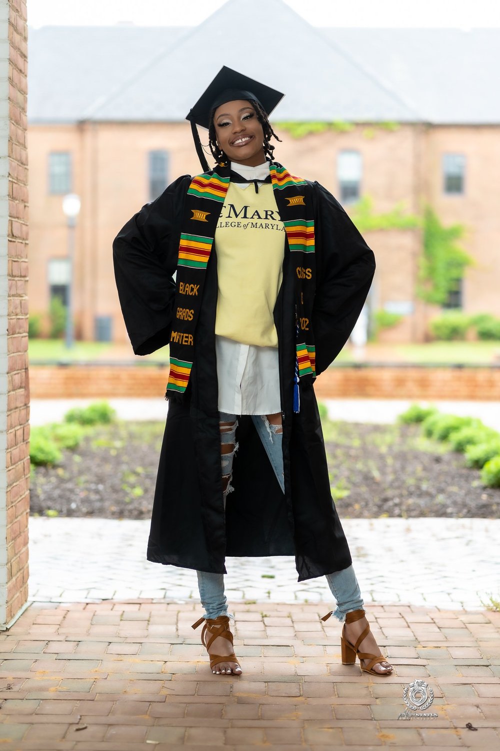 Graduate in cap and gown with honour stoles