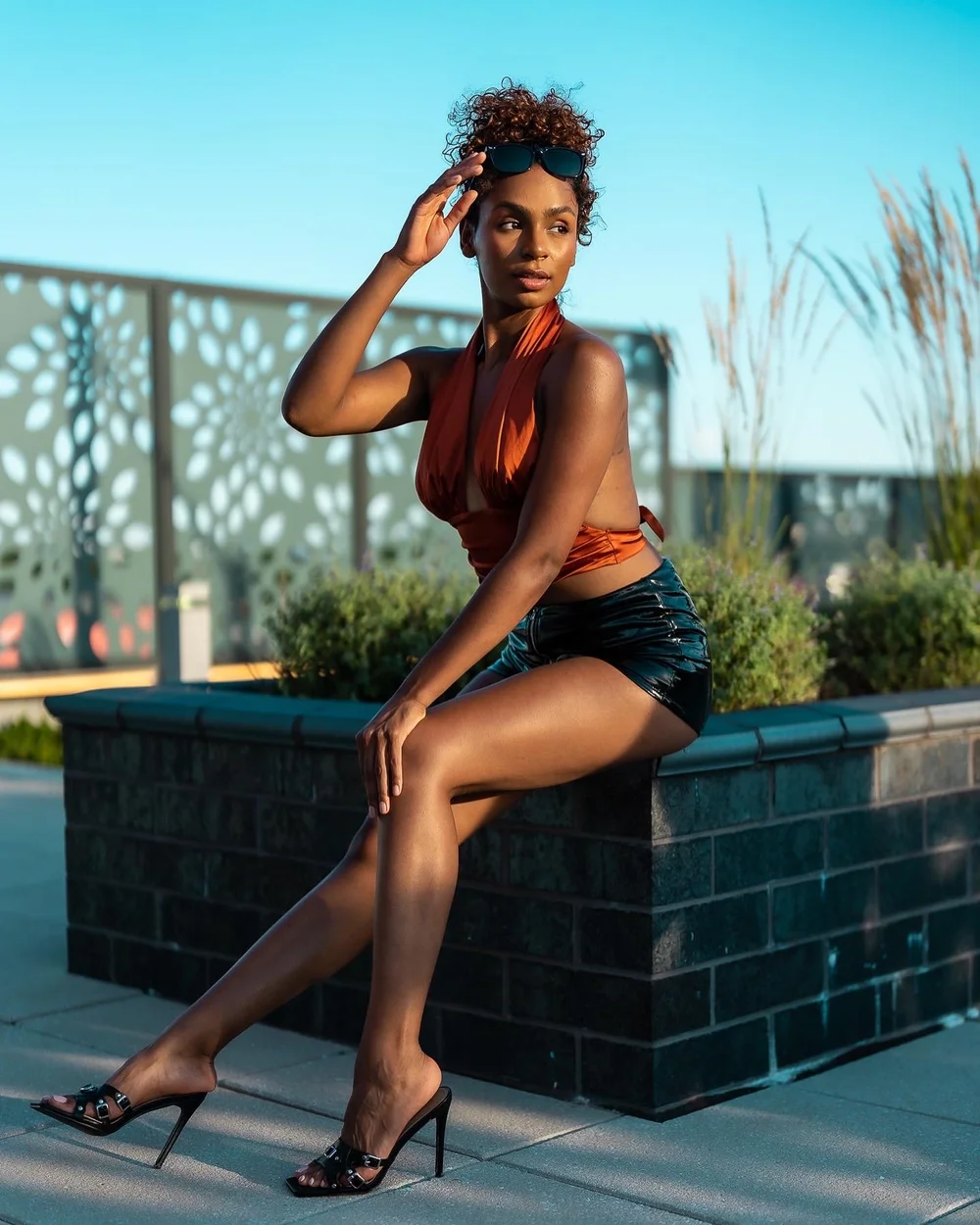 Seated portrait on a stone ledge outdoors