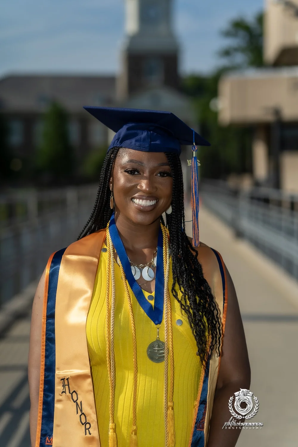 Graduate smiling in cap and gown in Maryland