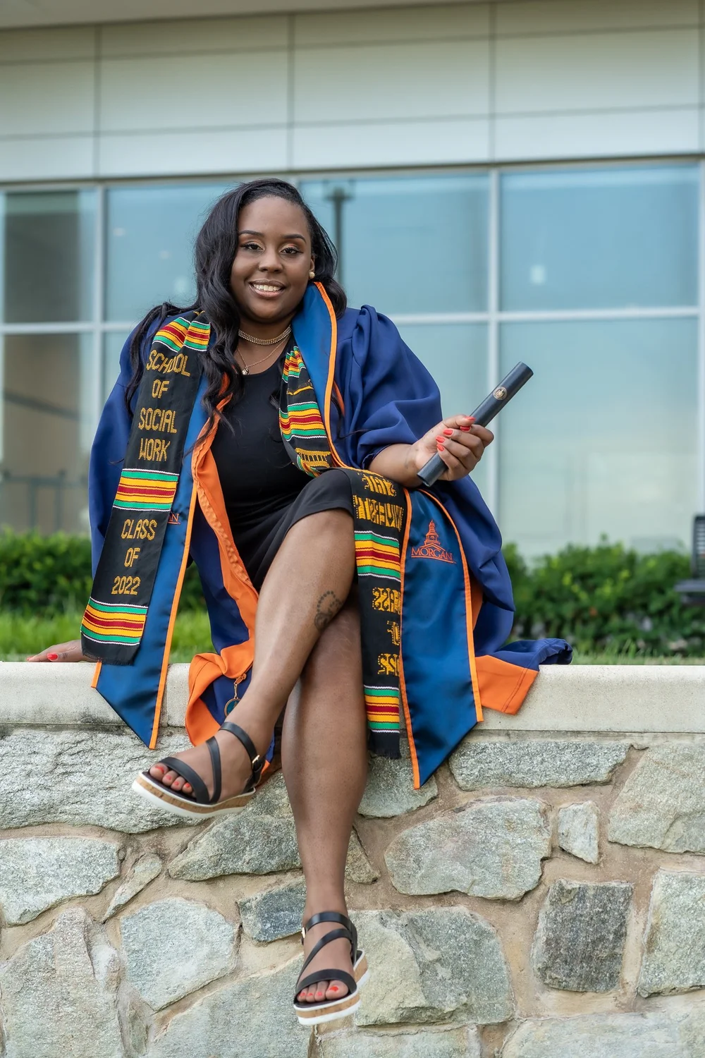 Seated graduate portrait in cap and gown