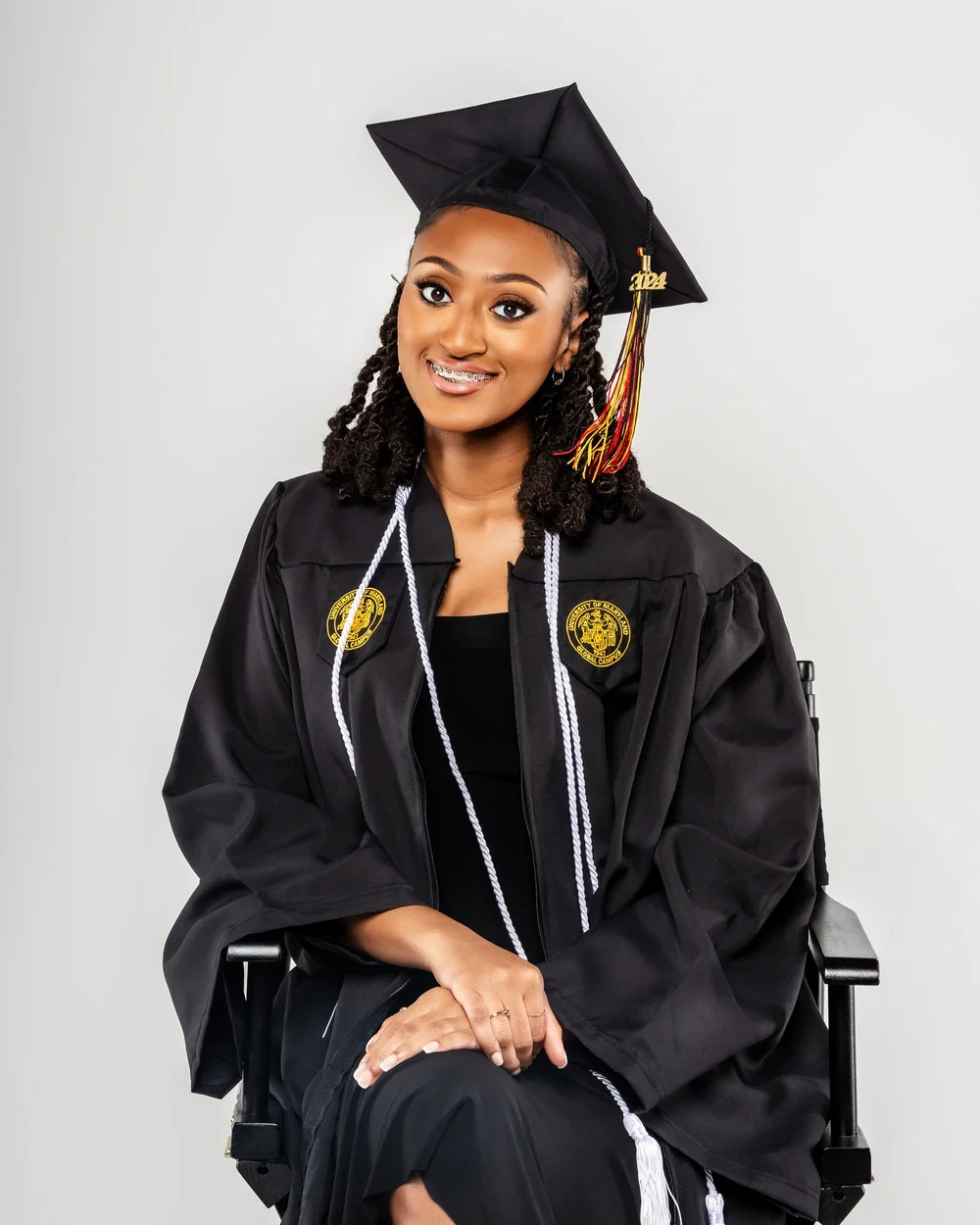 Graduate in black with a graduation stole