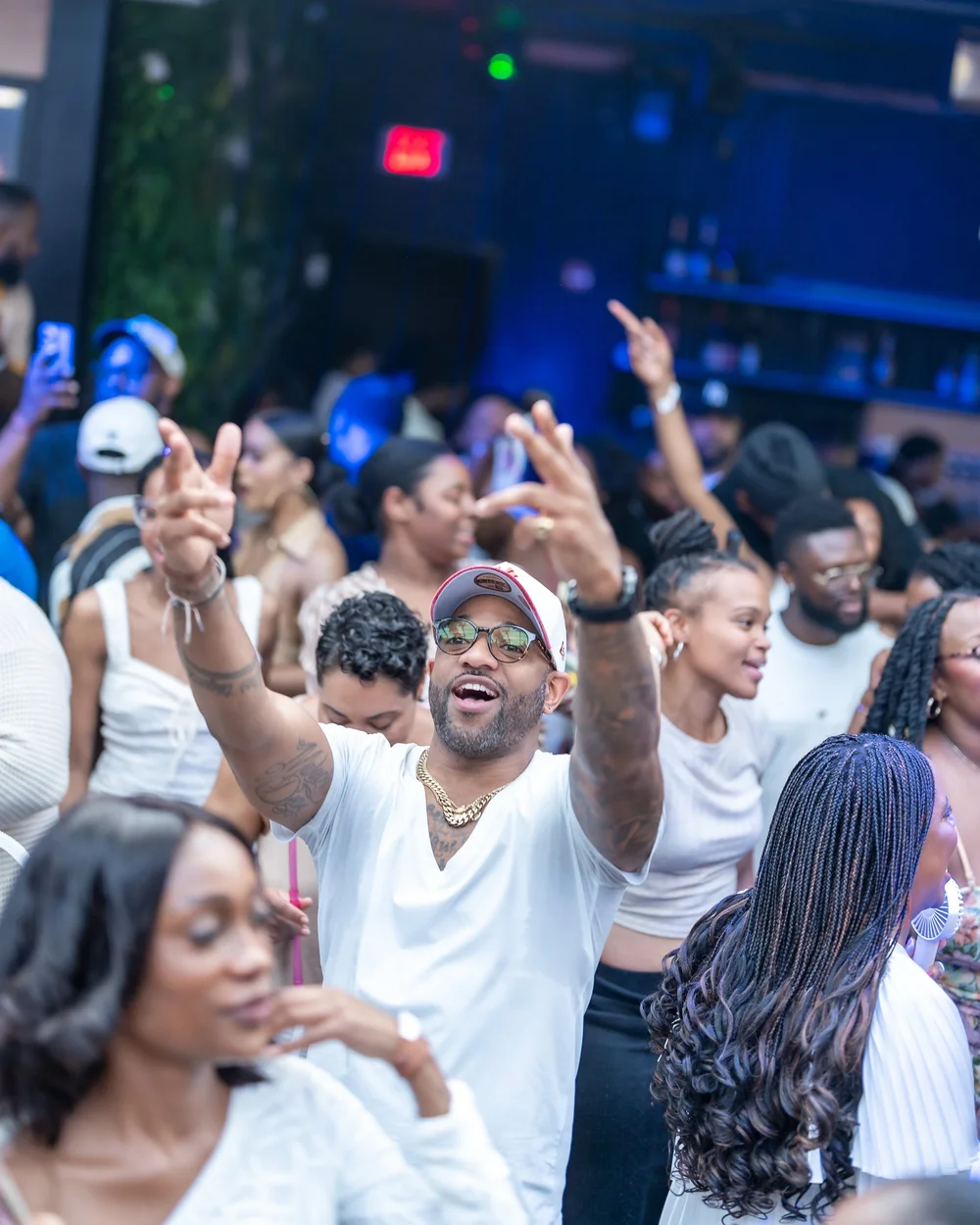 Packed dance floor with hands raised at a Maryland day party