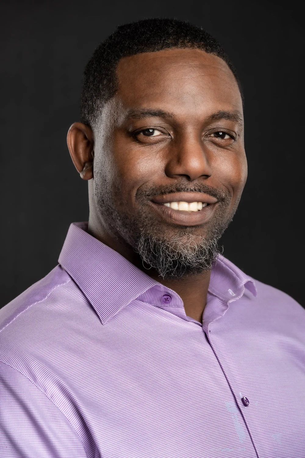 Professional headshot portrait of a man in a purple shirt, by Marcus Gregory Photography