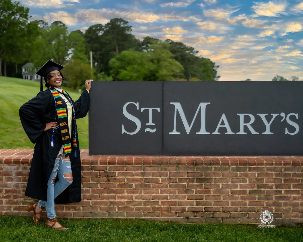 Graduate at the St. Mary's College sign