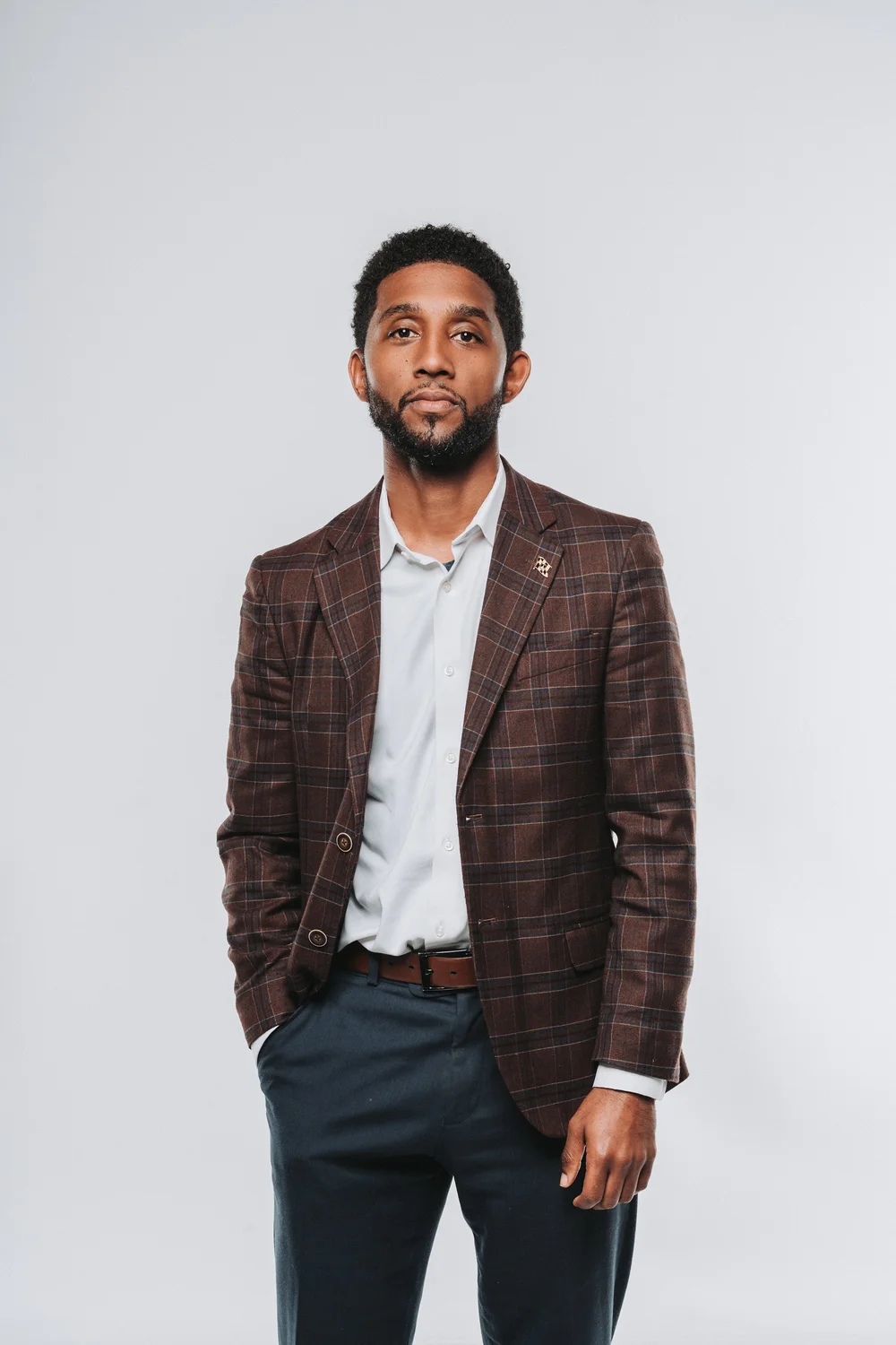 Studio portrait of a man in a white blazer