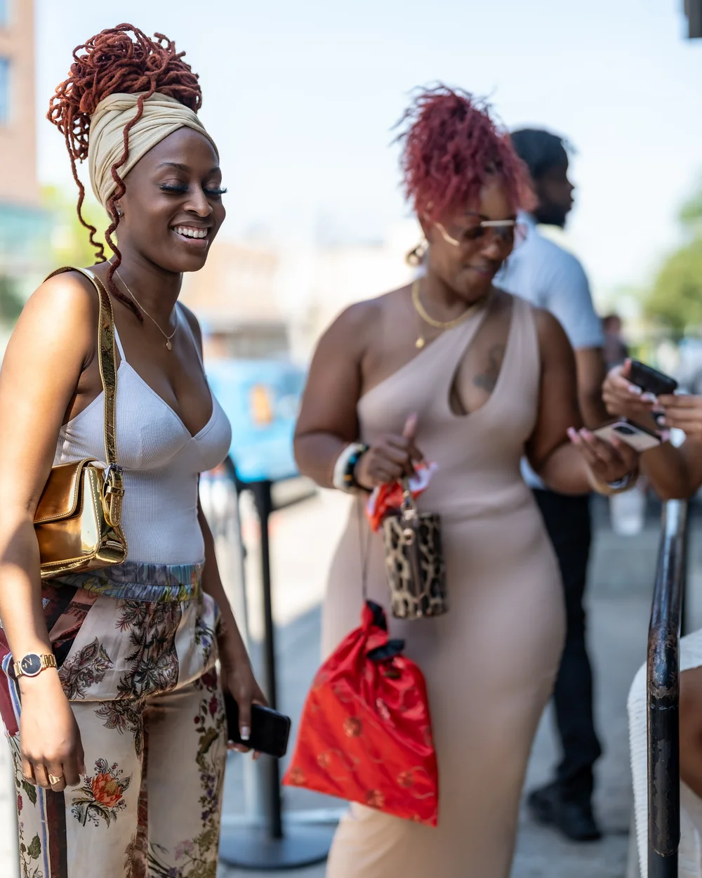 Two friends in white posing together at a Baltimore day party