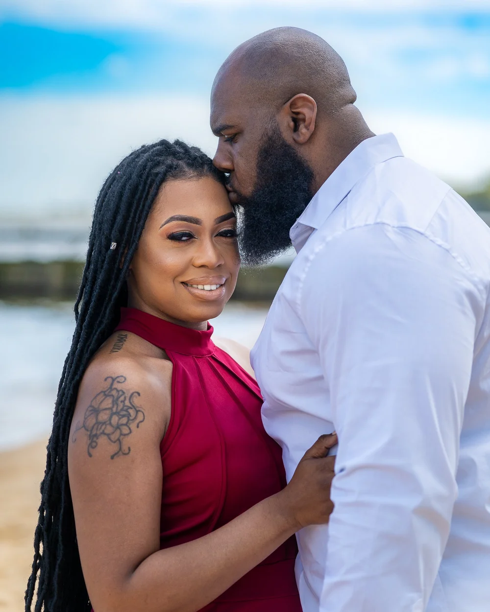 Engagement portrait of a couple in white and pink