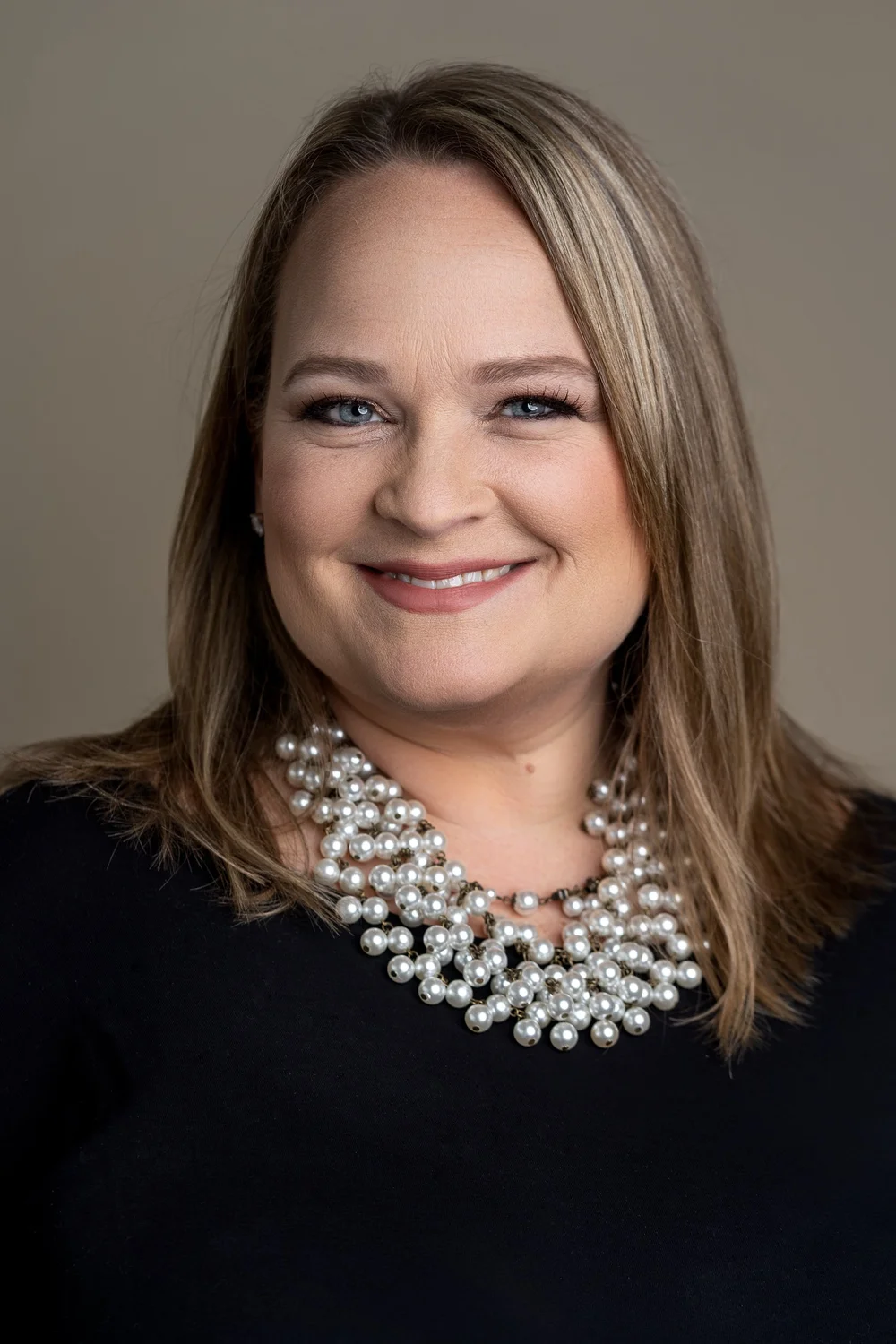 Professional business headshot portrait of a woman in a statement necklace, by Marcus Gregory Photography