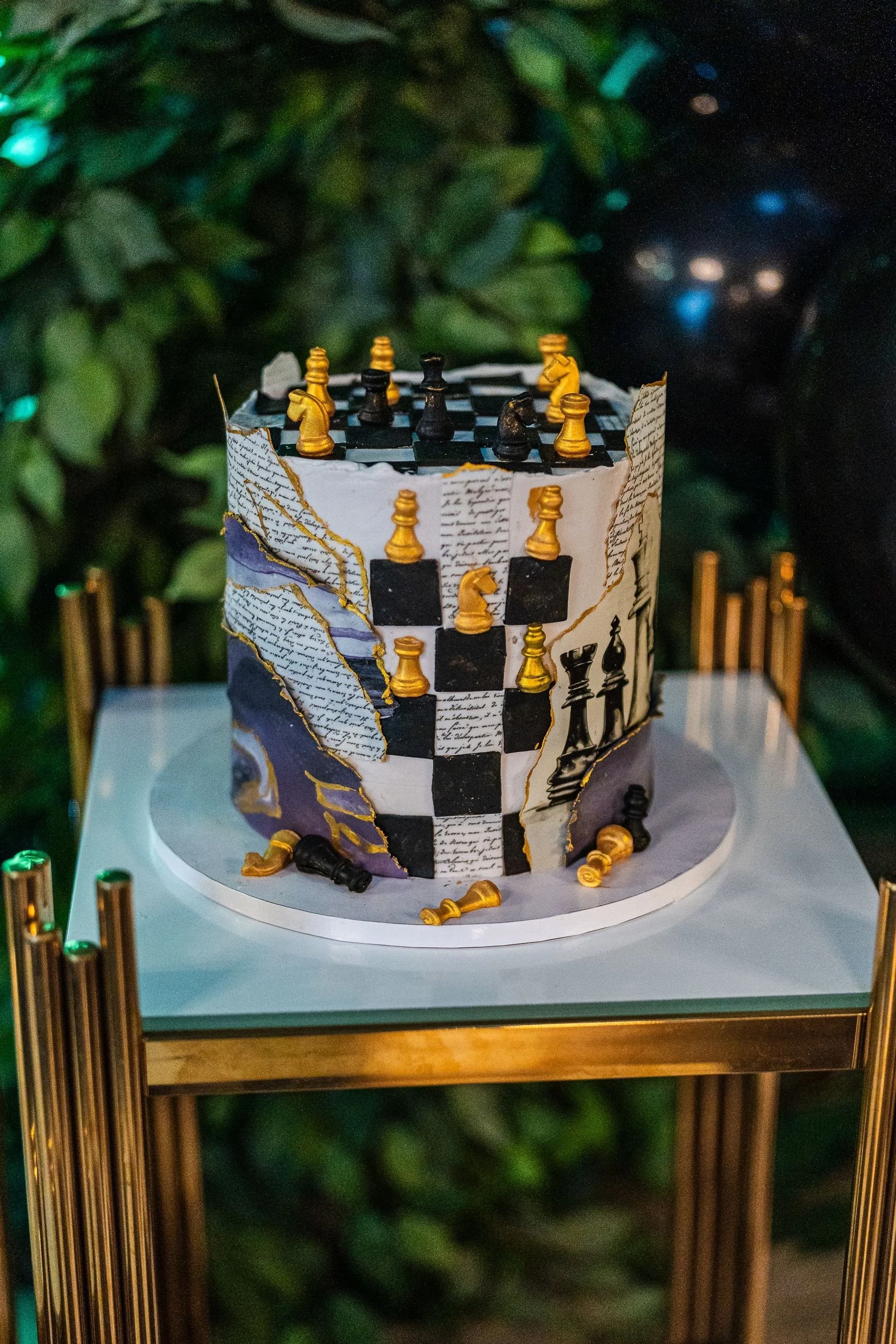 Black-and-gold checkered birthday cake with a gold crown topper