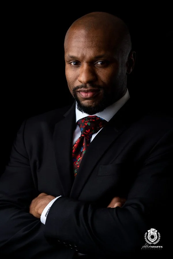 Professional business headshot portrait on a dark studio backdrop, by Marcus Gregory Photography
