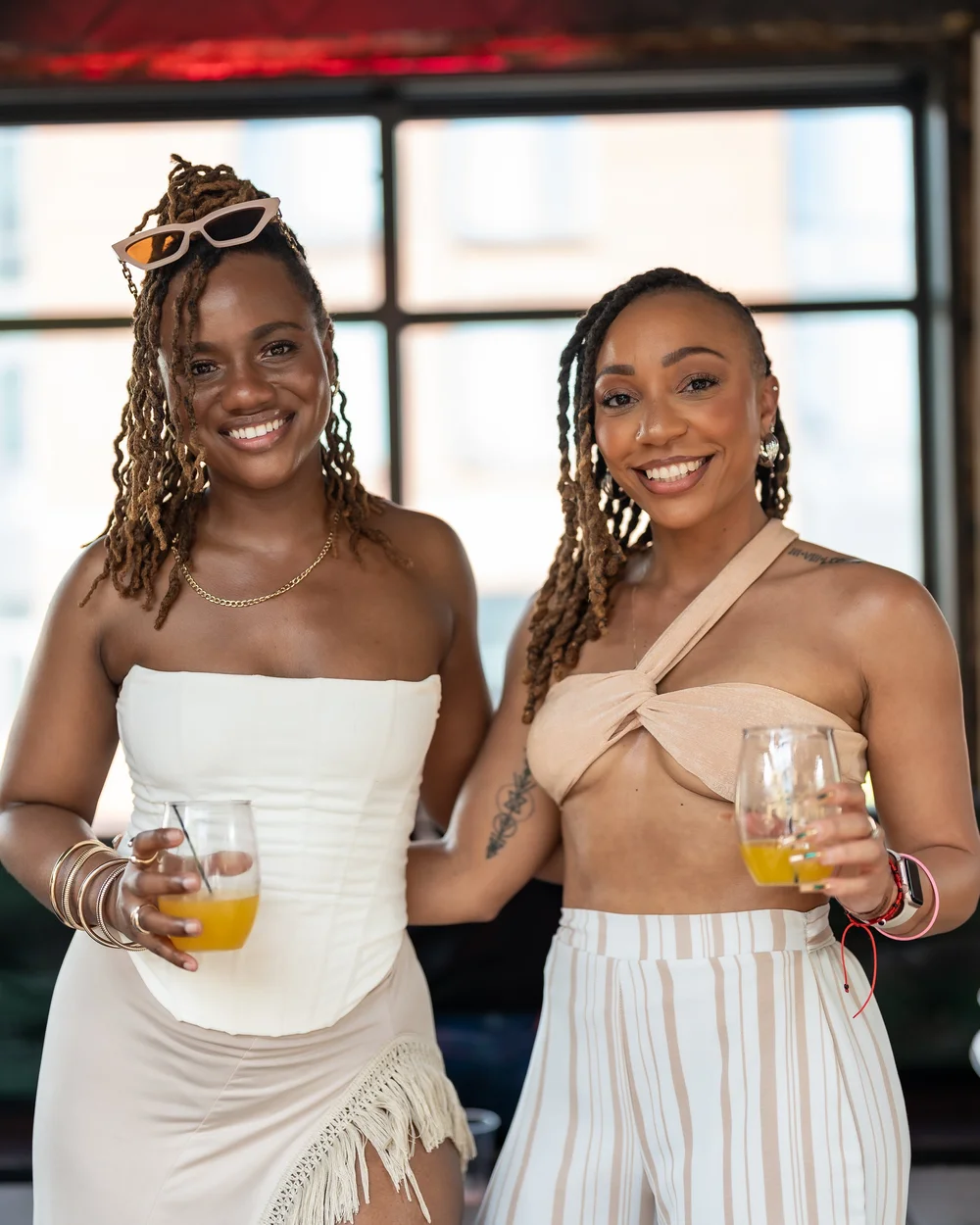 Two friends posing together at an all-white affair in Maryland