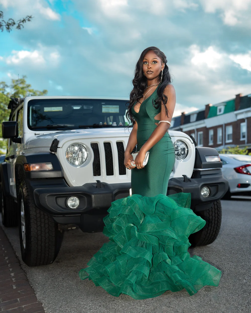 Prom sendoff with a green mermaid gown beside a Jeep