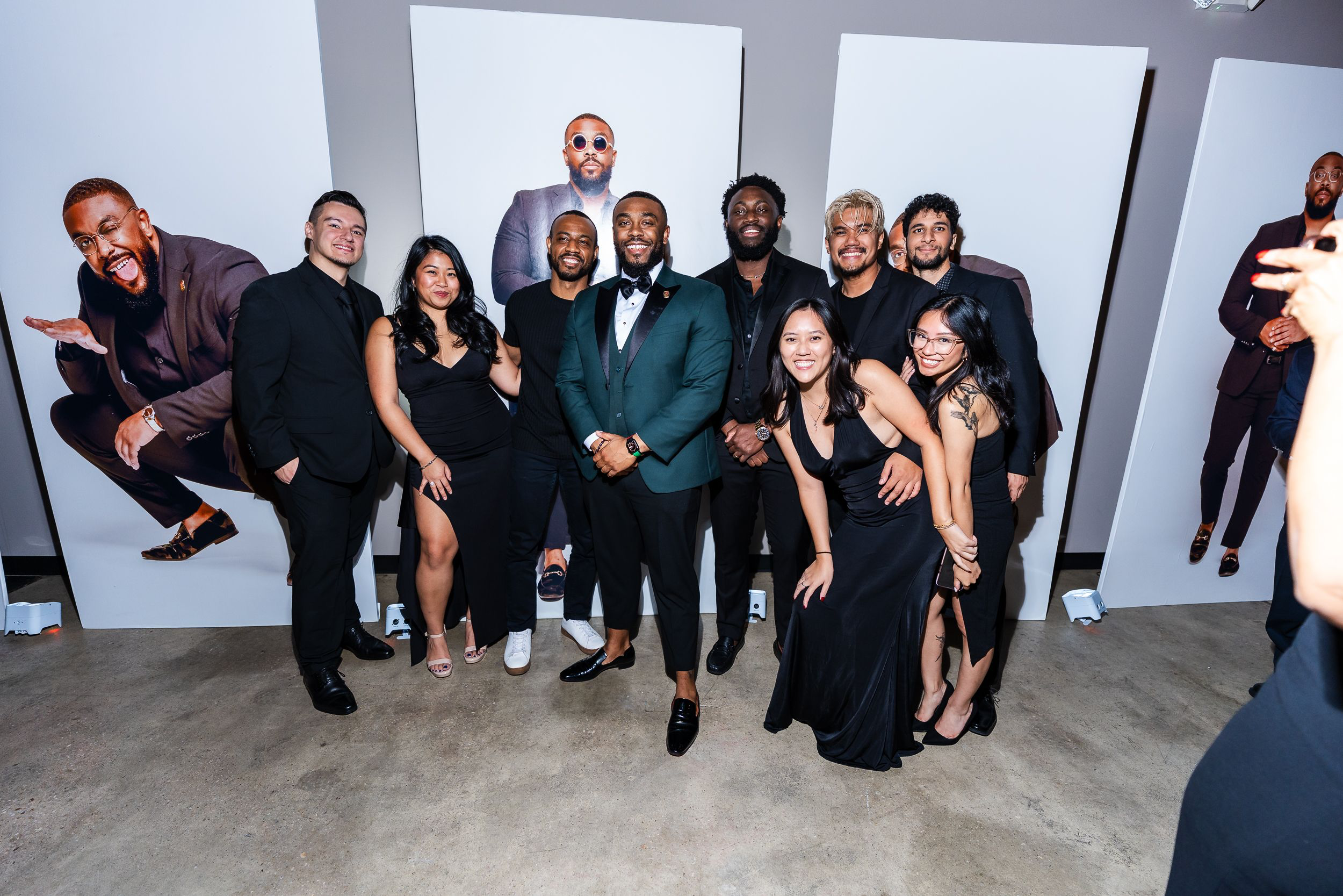 Wide group portrait of guests at a black-tie birthday celebration