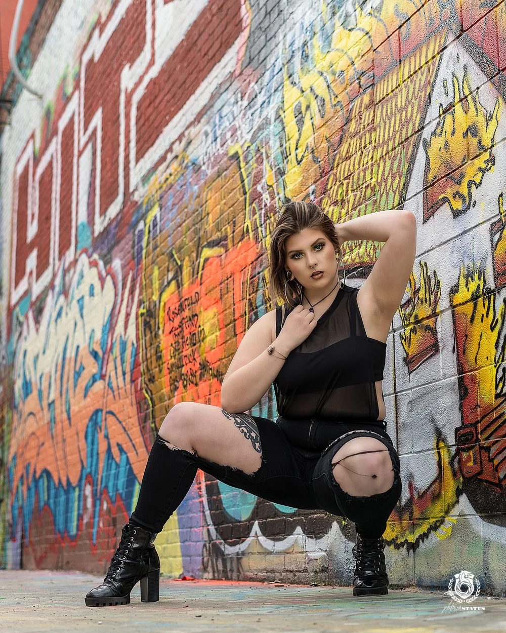 Portrait against a graffiti mural in Baltimore