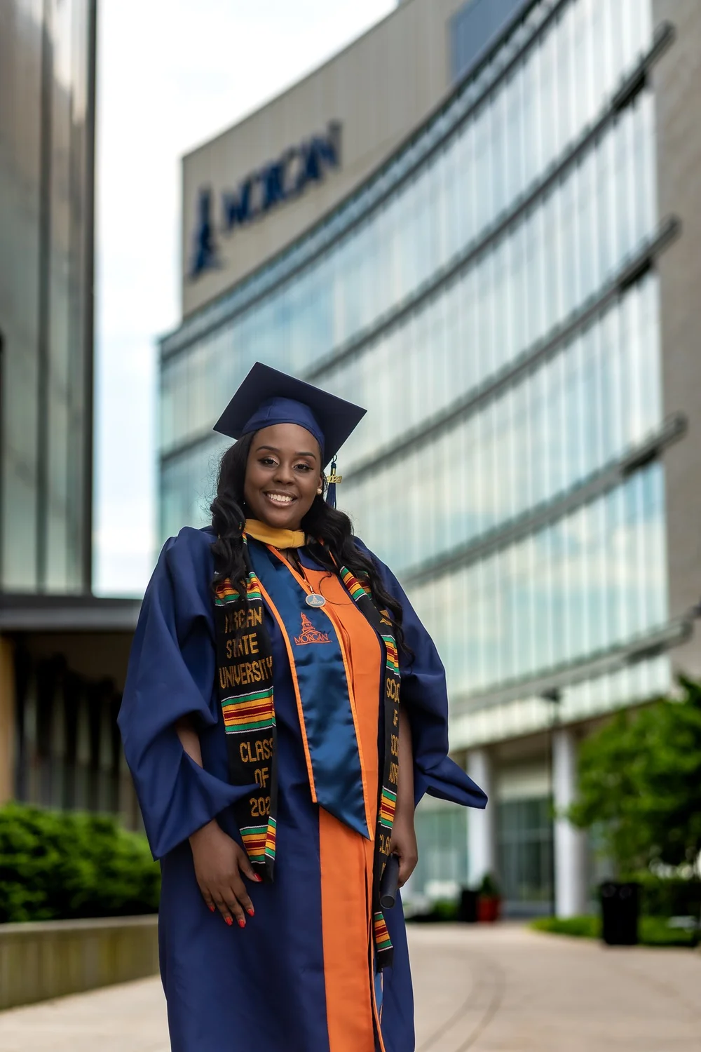 Graduate in navy cap and gown
