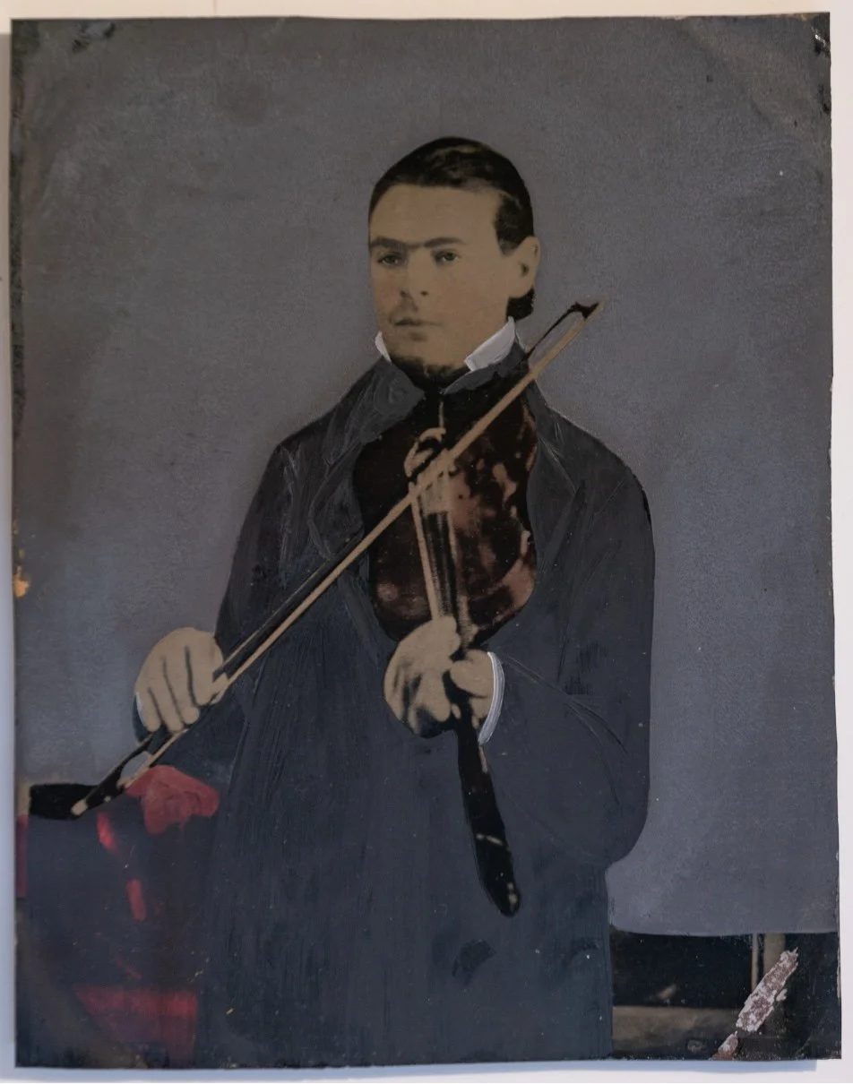 man with slicked hair holding violin, (1875)