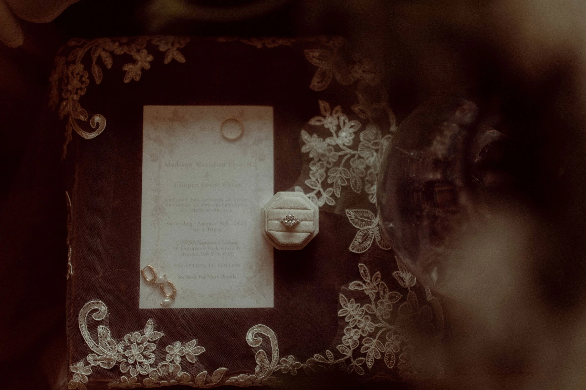 Wedding rings and bride's veil with lace detail, Alberta wedding photographer