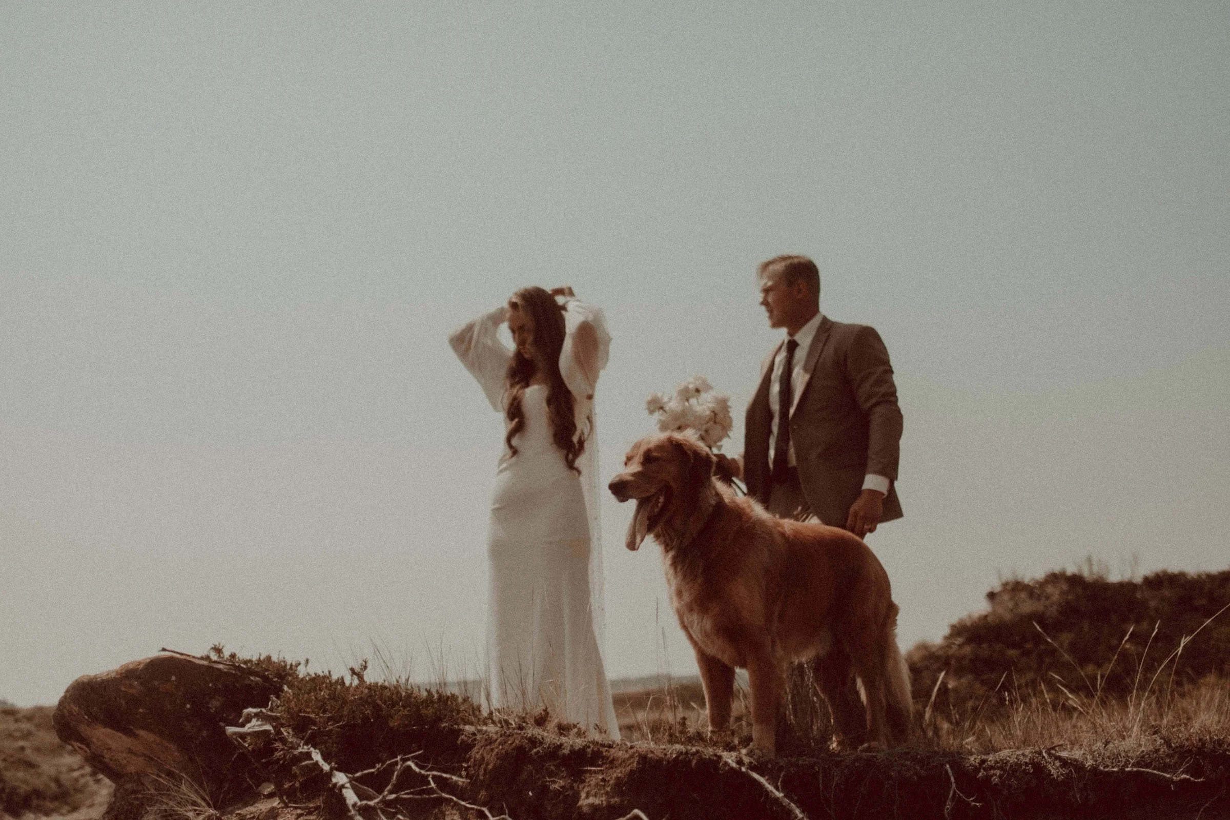 A couple on their wedding day in central alberta with their dog