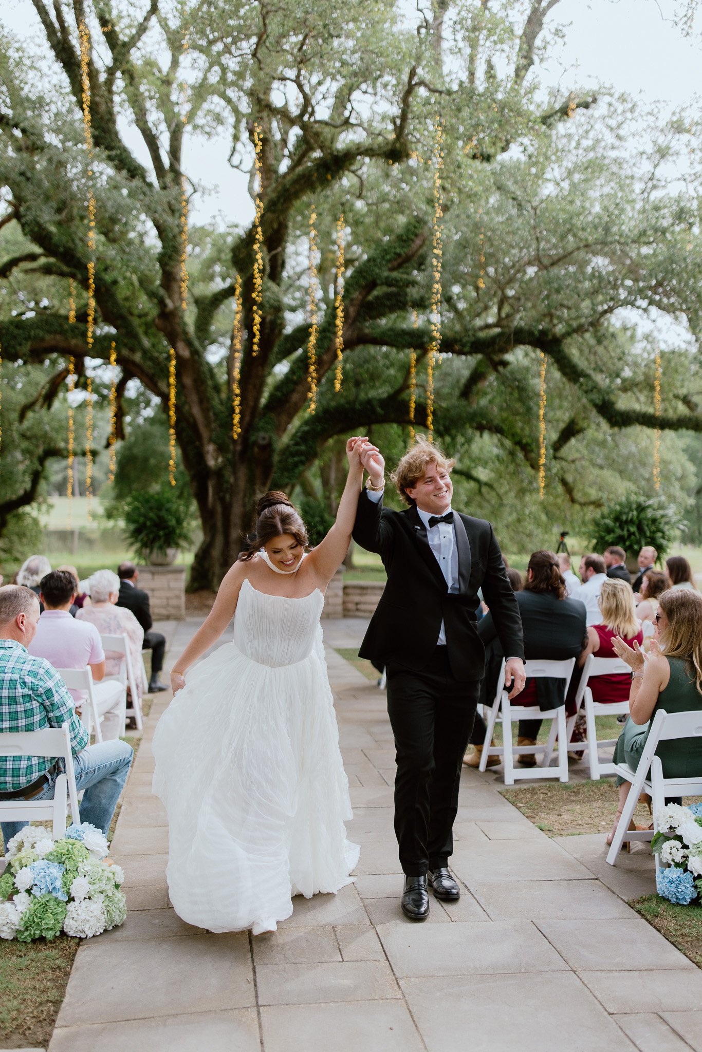 Newlyweds walking back down the aisle after their outdoor wedding ceremony