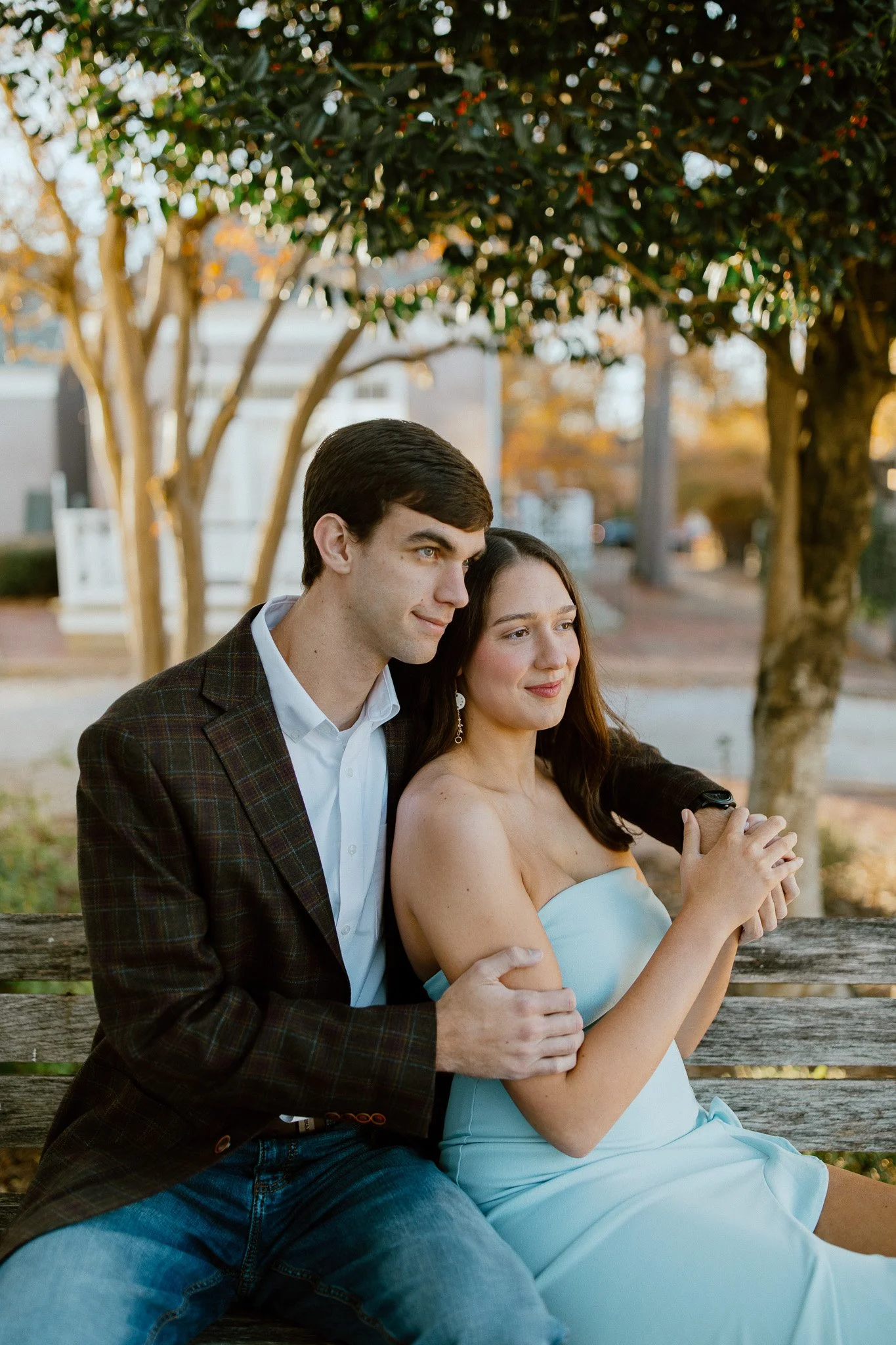 Engaged couple embracing during an outdoor portrait session in Cotton District, Starkville Mississippi
