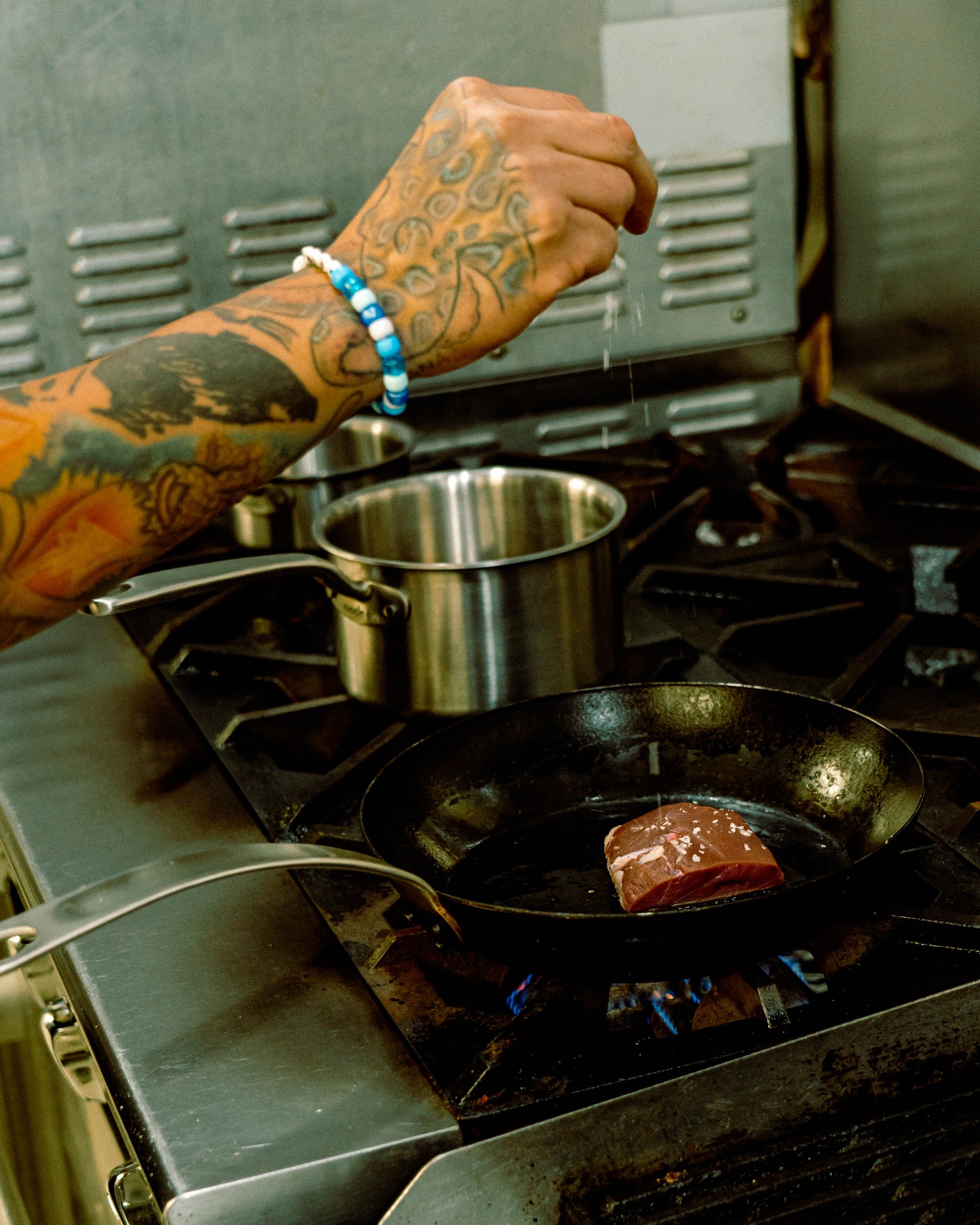 Chef Daniel Gaspar cooking duck on a Carbon Steel Pan from Made In Cookware. Using a 2 quart pot and a butter warmer for sauce and puree. Photograph by Cameron Kisel for Daffodil Culinary and Catering in Austin, TX.