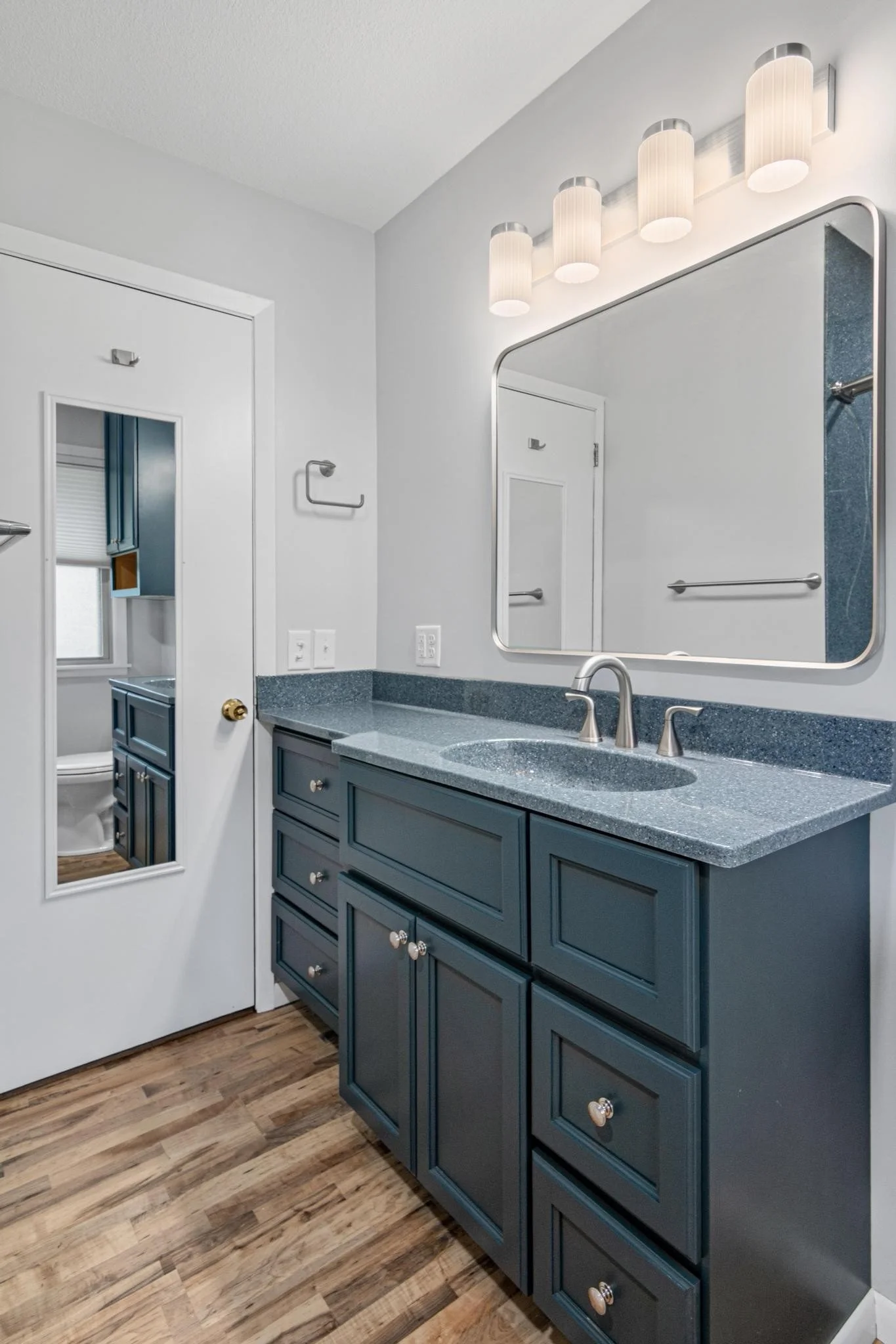 Bathroom remodel using onyx shower panels and onyx vanity top and sink with custom vanity and toilet cabinet and lvp flooring