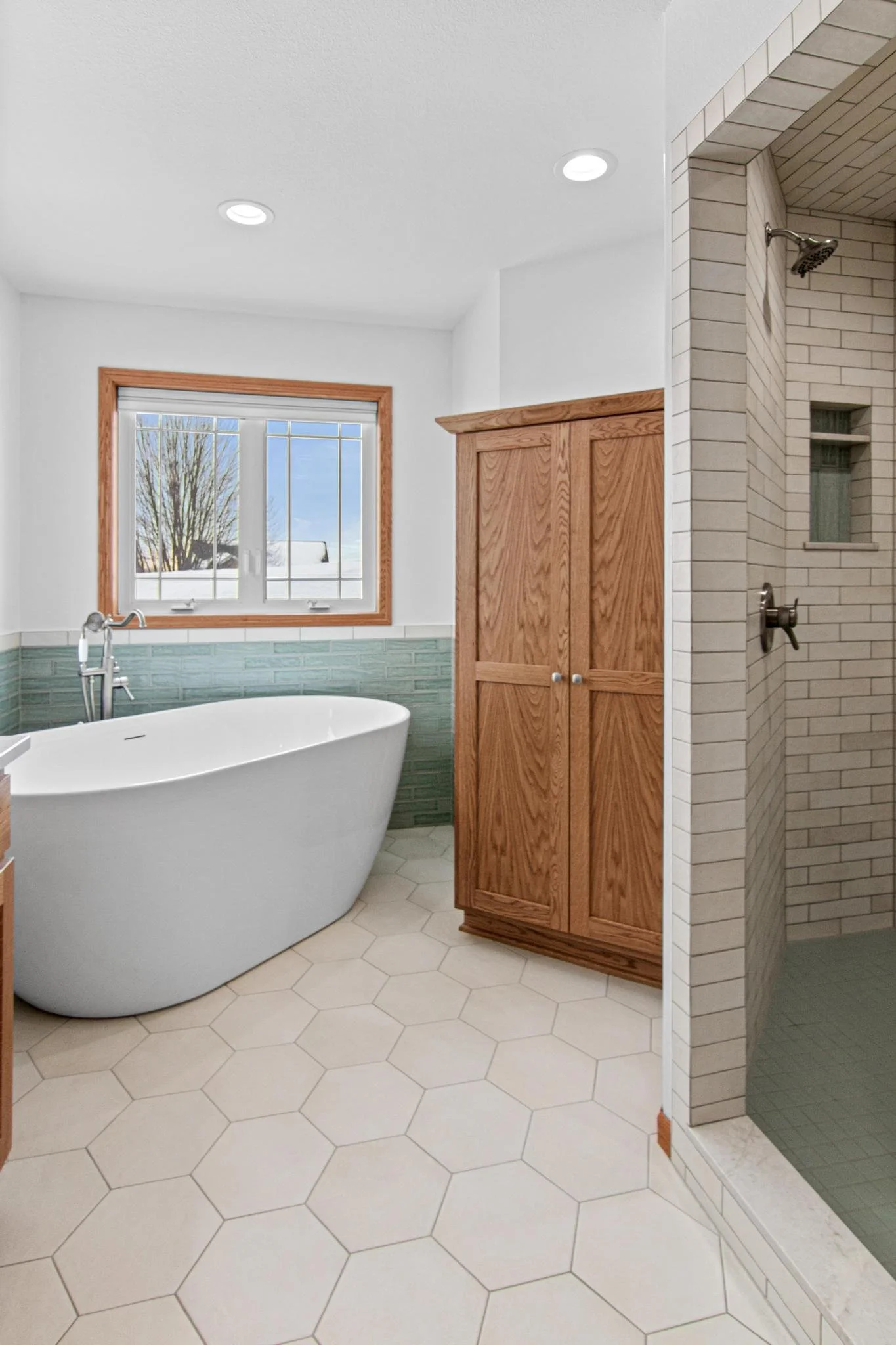 Master bathroom remodel white hex tile freestanding tub custom cabinetry tile shower