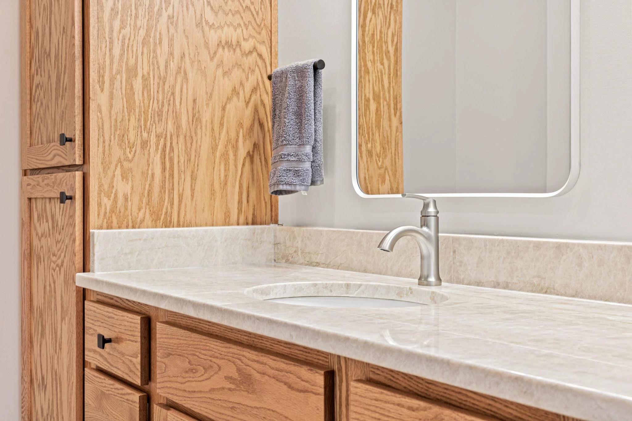 Bathroom Remodel with a freestanding tub quartz countertops and custom golden oak vanity