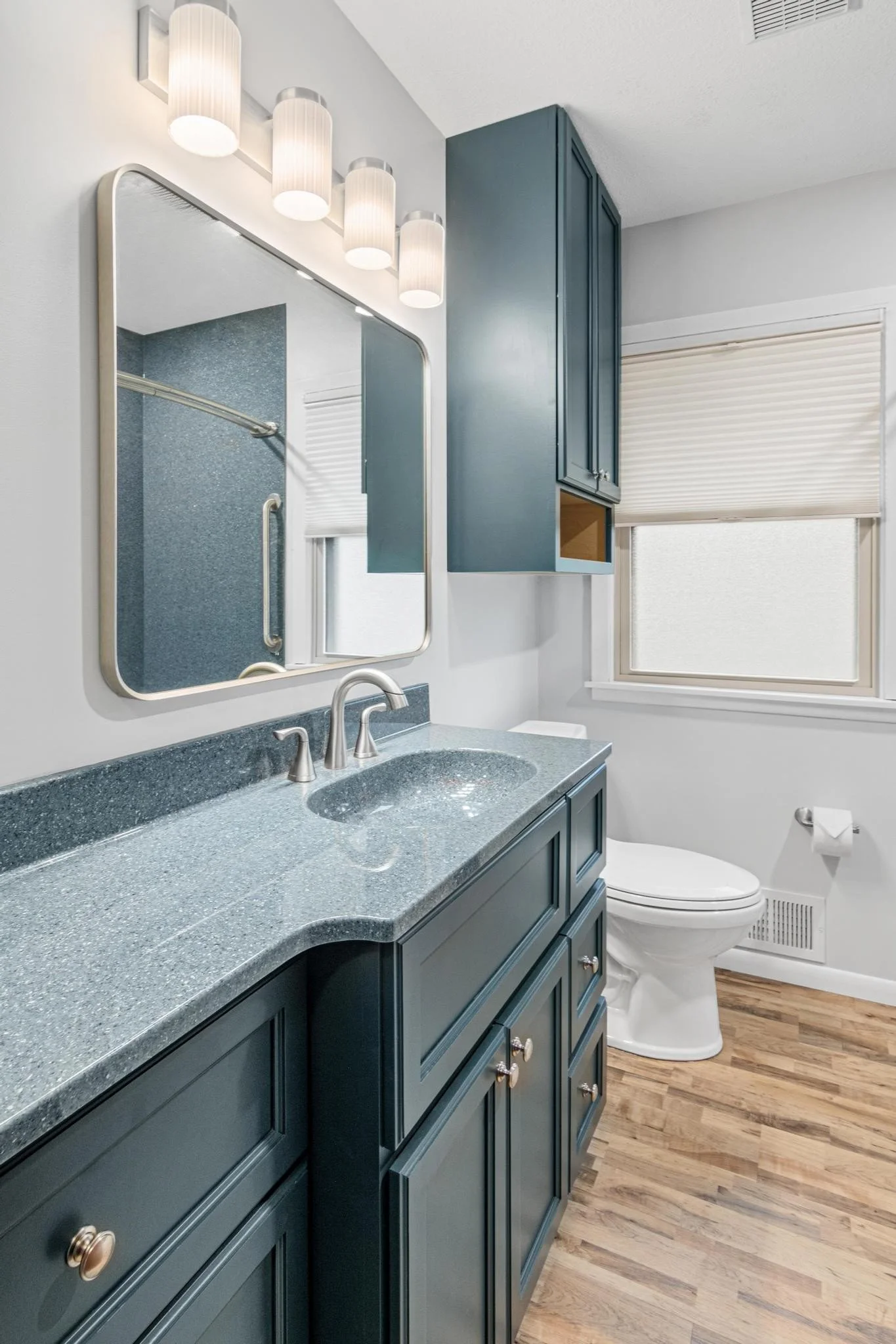 Bathroom remodel using onyx shower panels and onyx vanity top and sink with custom vanity and toilet cabinet and lvp flooring