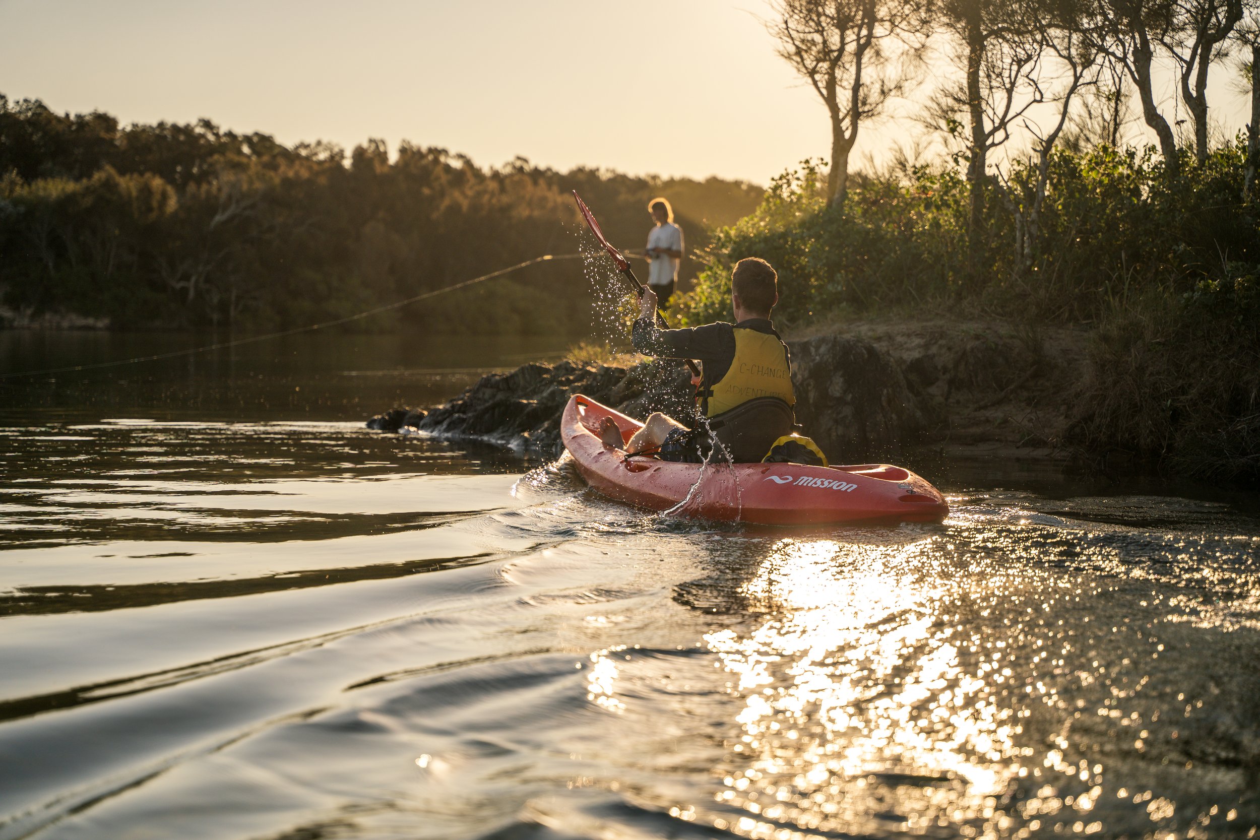 Image of Kayaker paddling at sunset. Image taken by our team of photographers at Descent Productions.