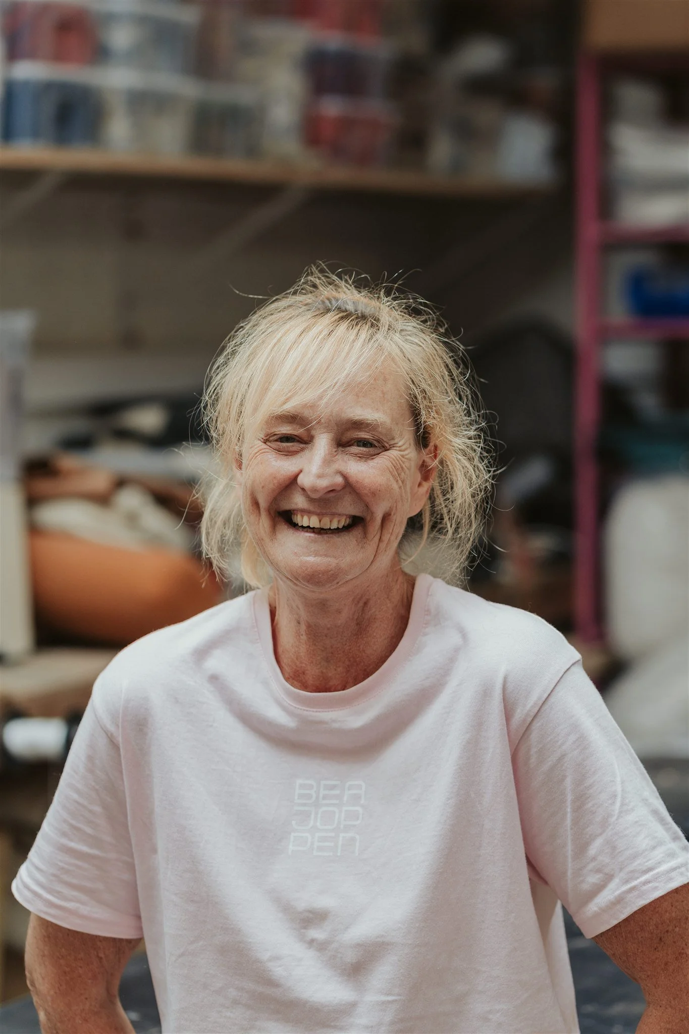 Bea Joppen smiling in her upholstery workshop in Antwerp.