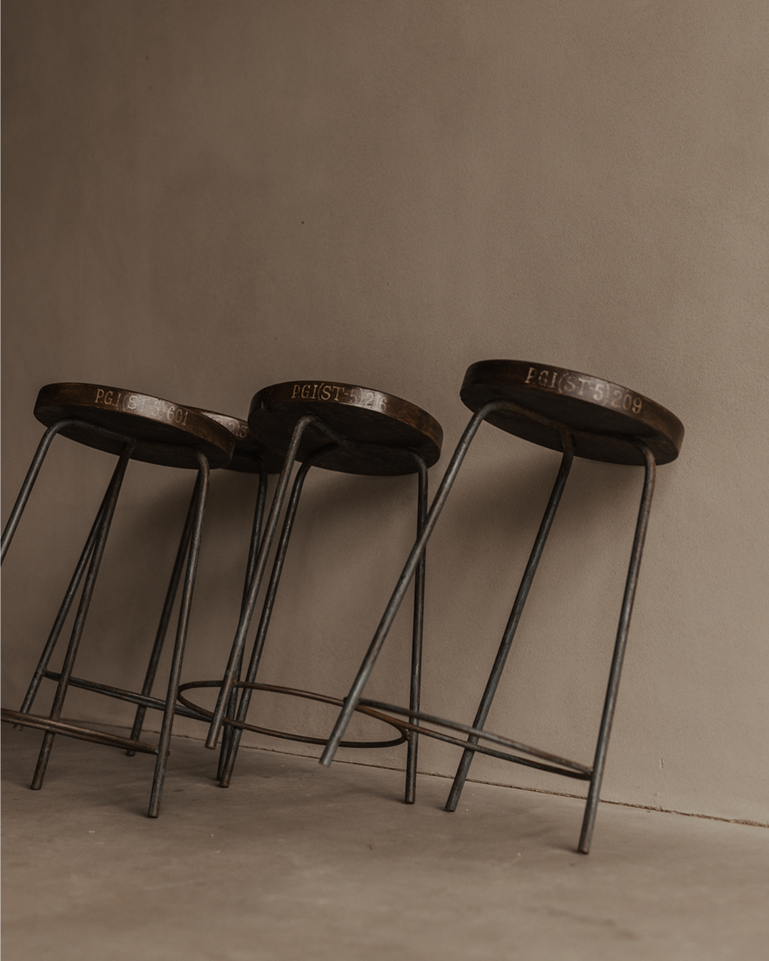 Set of four vintage teak stools with concave seats and original blue-grey iron bases, from Chandigarh P.G.I.