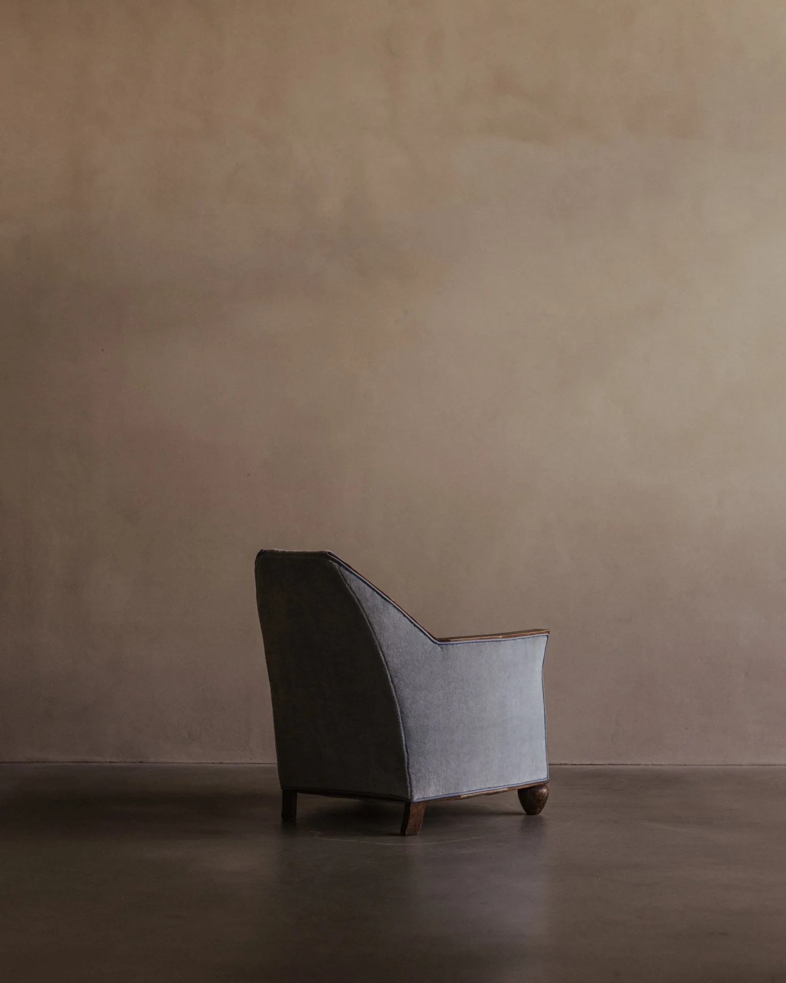 Back view of Art Deco armchair, upholstered in blue mohair, showing splayed rear legs