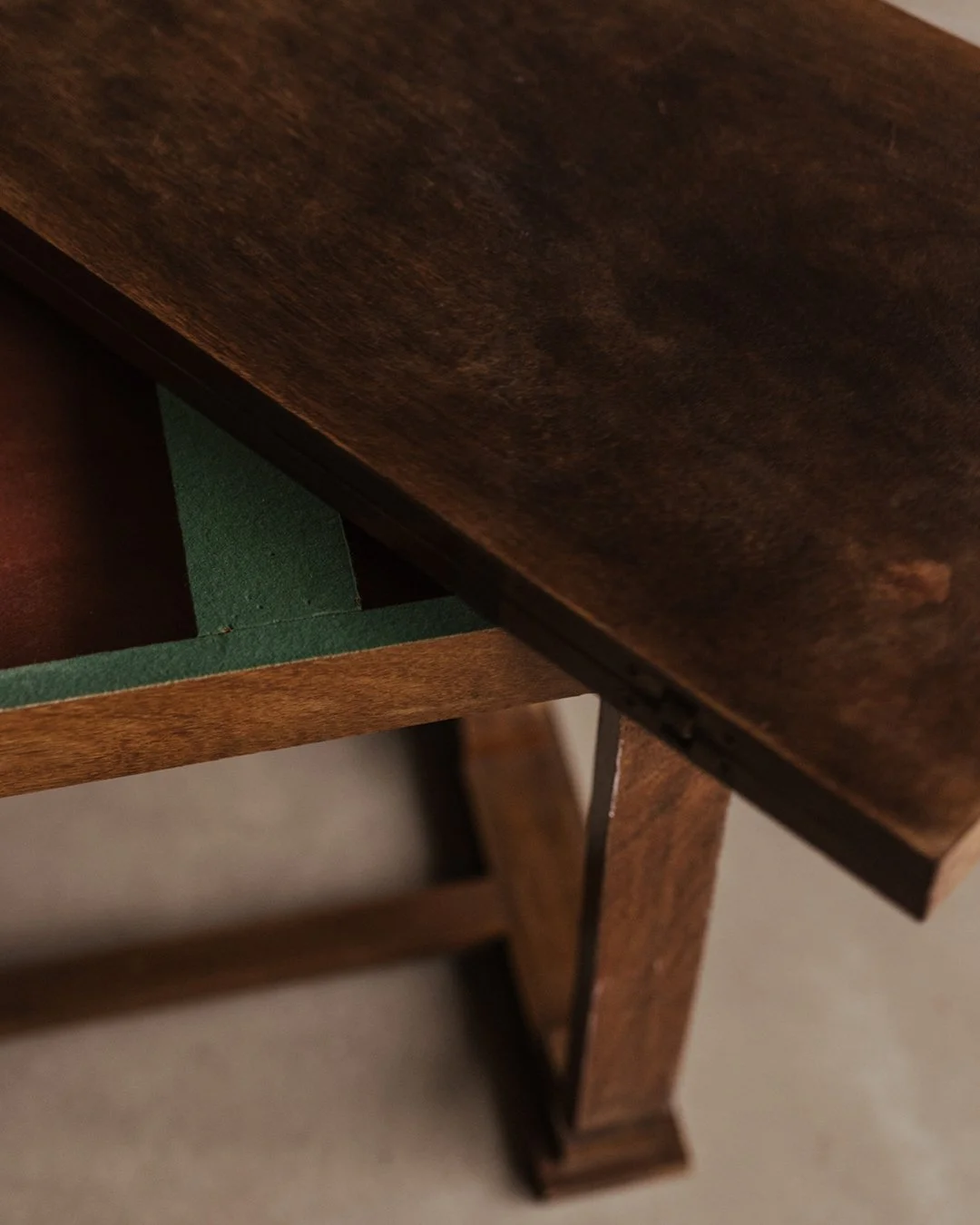 Art Deco mahogany gaming table designed by André Léon Arbus with foldable top, Greek key pattern edge, green felt inlay and brass hardware.