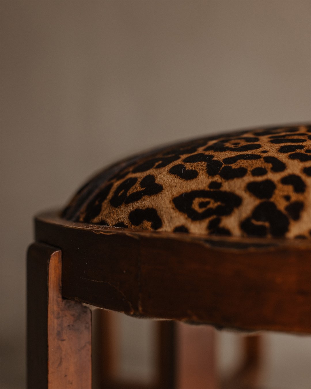 Pair of Art Deco wooden stools with round faux-leopard seats, early 20th century