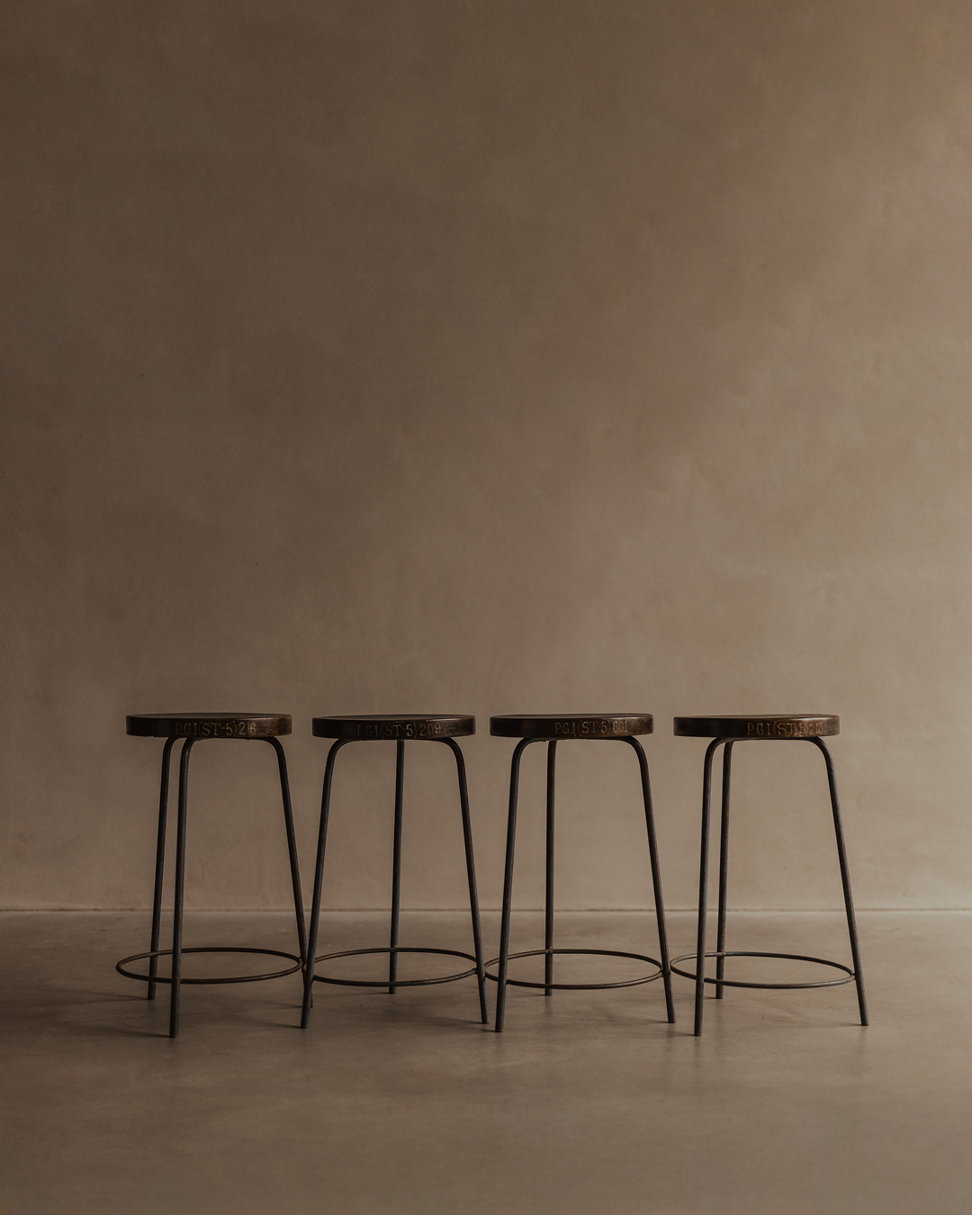 Set of four vintage teak stools with concave seats and original blue-grey iron bases, from Chandigarh P.G.I.