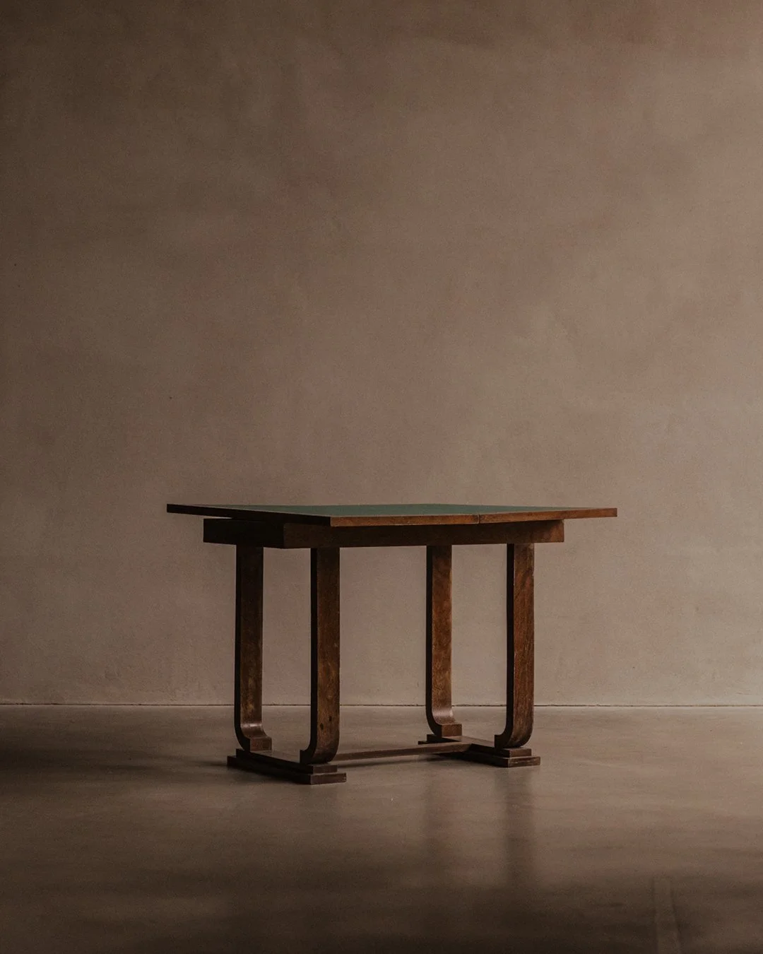 Art Deco mahogany gaming table designed by André Léon Arbus with foldable top, Greek key pattern edge, green felt inlay and brass hardware.