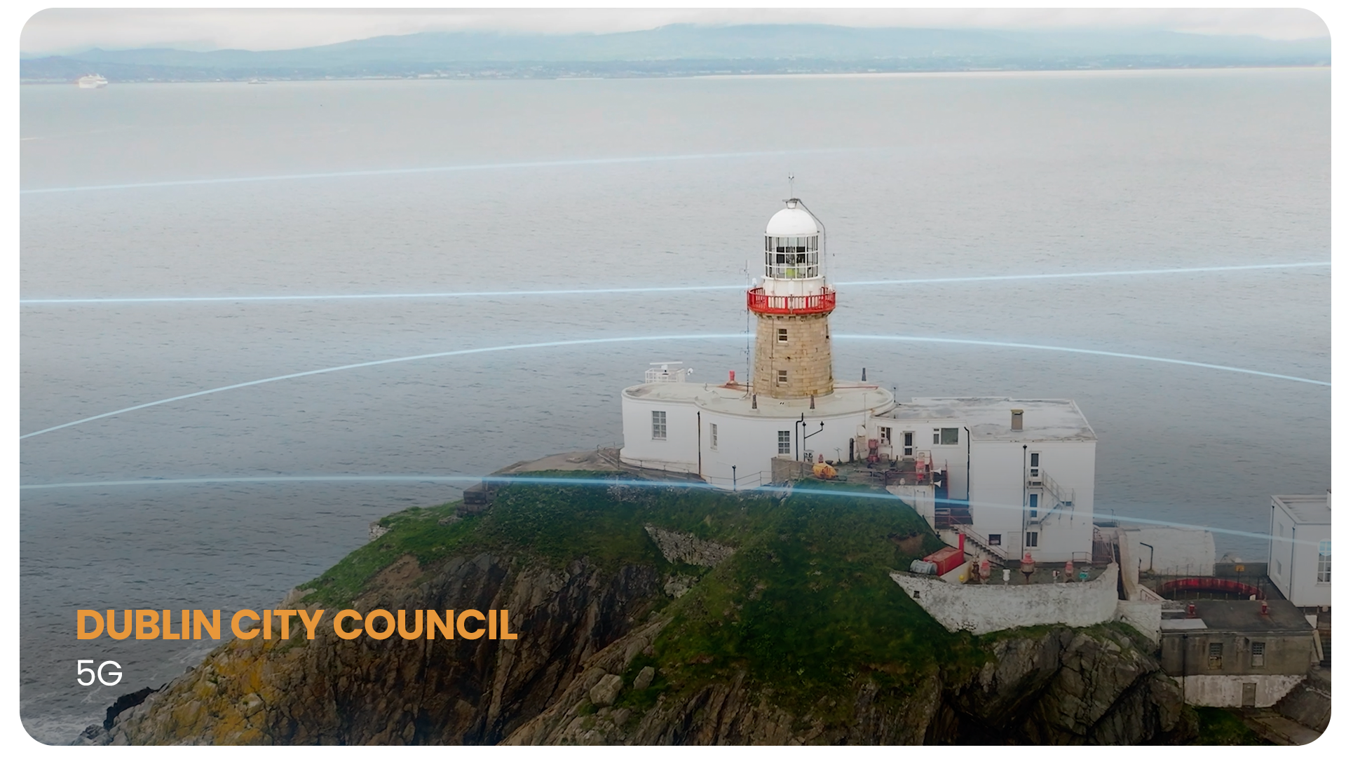 A lighthouse situated on a rocky hill by the sea with red and white colors. The photo has graphics of Wi-Fi signal lines overlayed, and the text 'DUBLIN CITY COUNCIL' with '5G' below in orange and white letters.