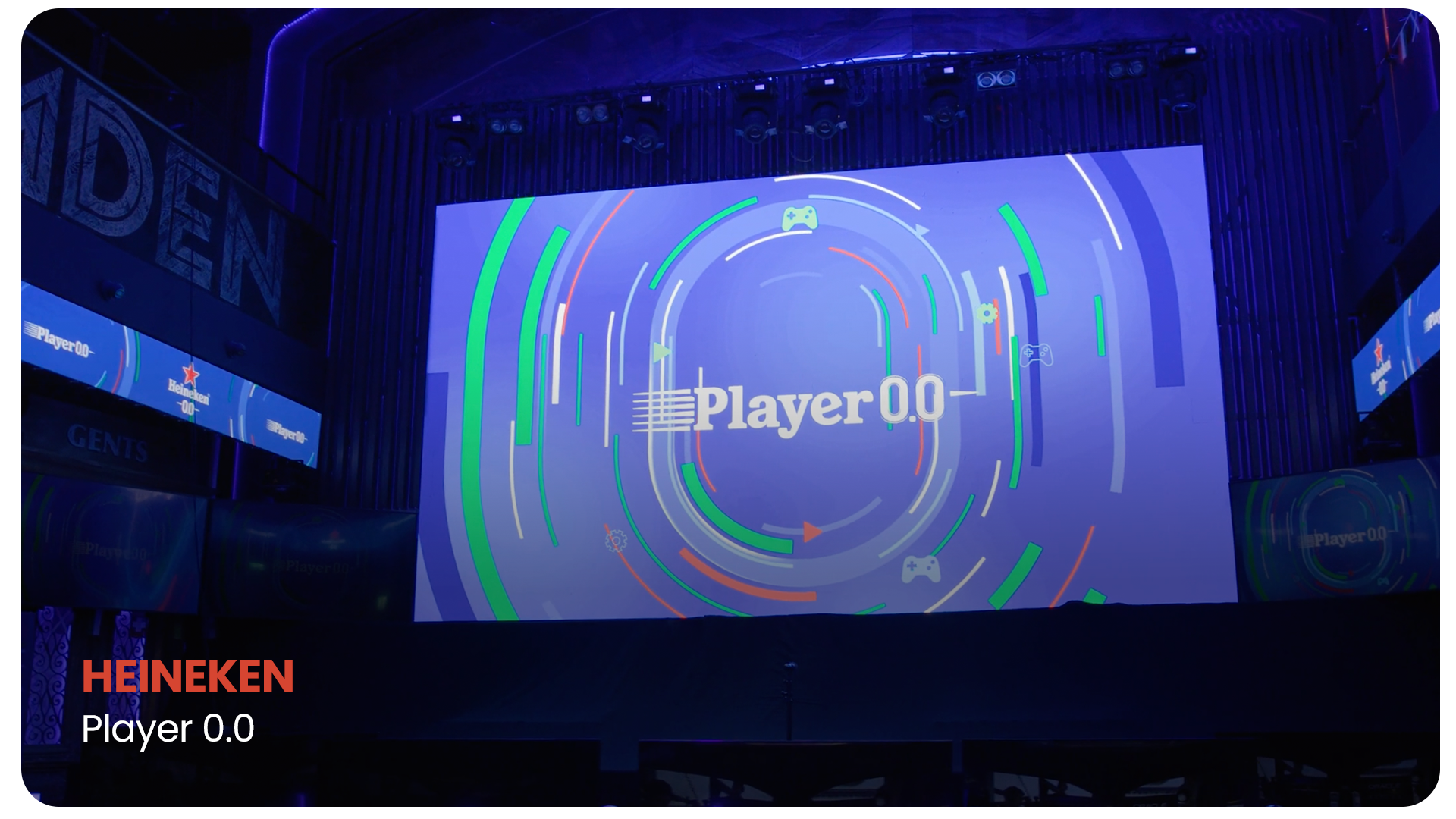 Large LED screen displays the Heineken Player 0.0 logo with colorful circular graphic design, located in a dimly lit event space with multiple smaller screens around.
