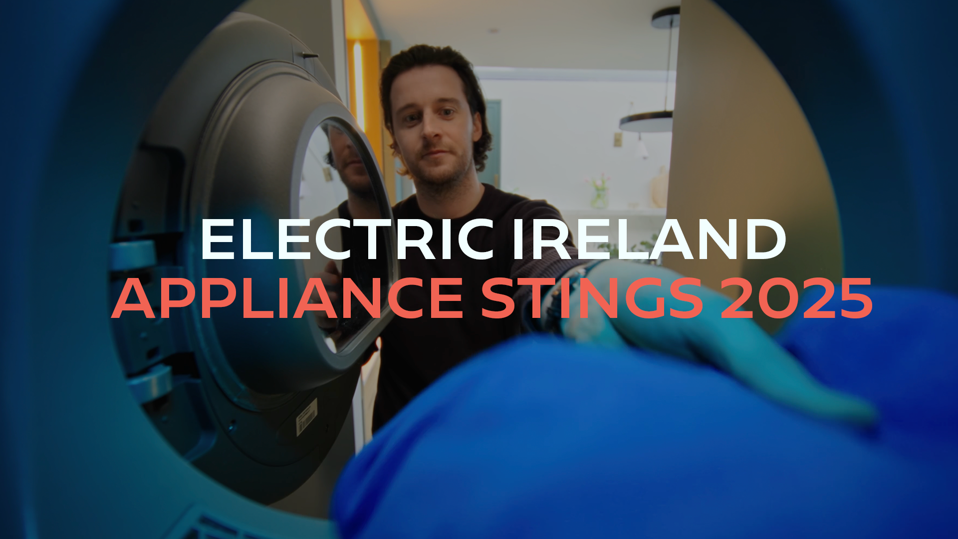 A man loading laundry into an electric washing machine, with the text 'Electric Ireland Appliance Stings 2025' overlaid.