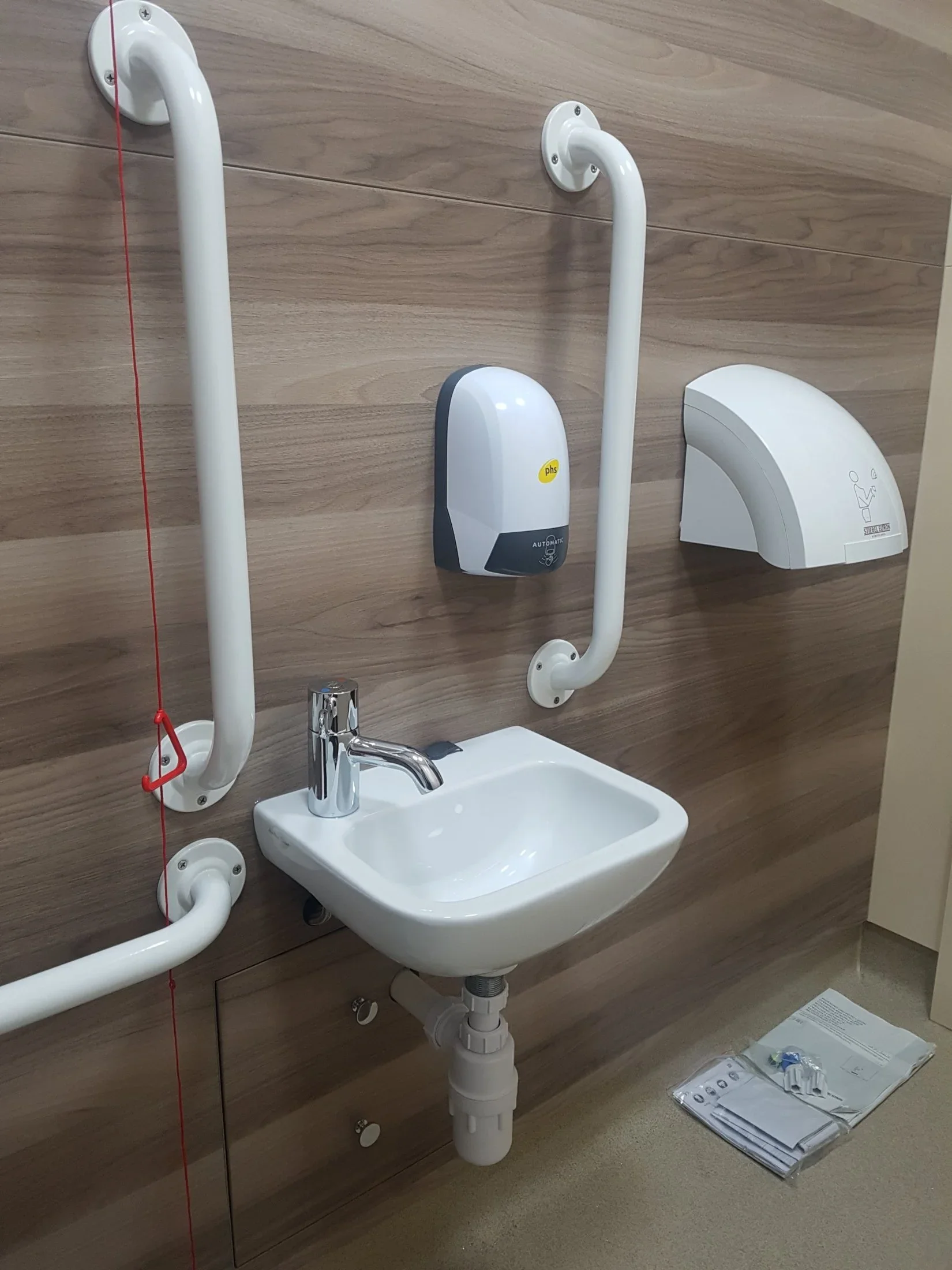 Accessible basin, grab rails and hand dryer in a Poole church WC