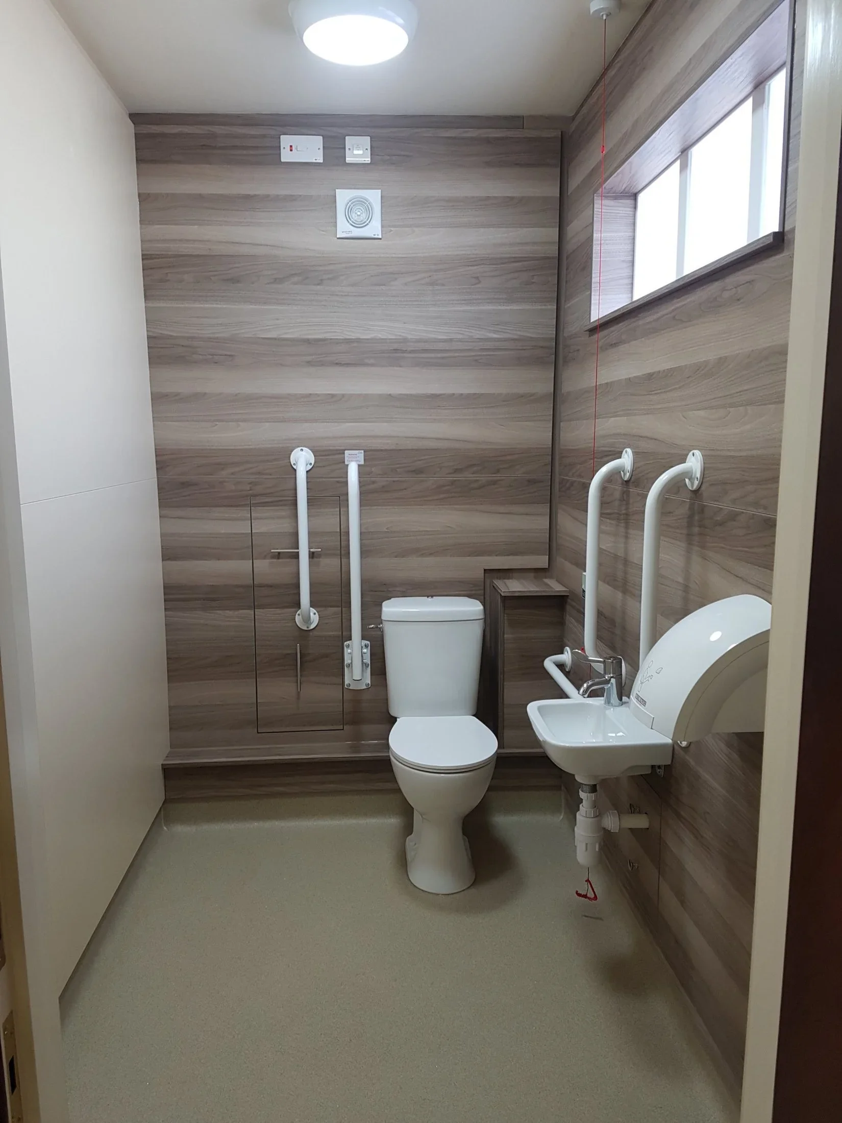 Accessible WC with grab rails at a church in Poole, Dorset