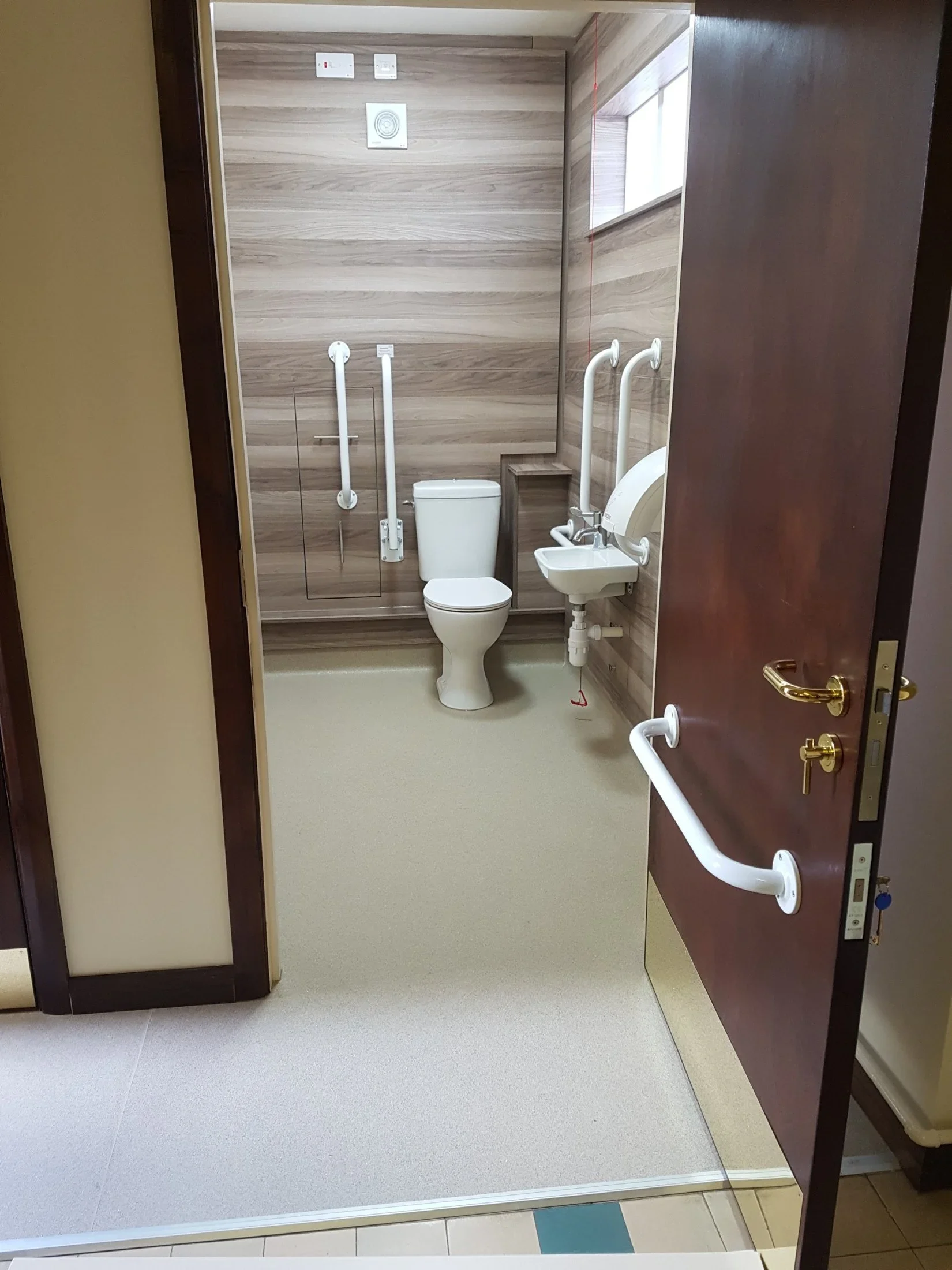 Level entrance to the accessible WC conversion at a church in Poole