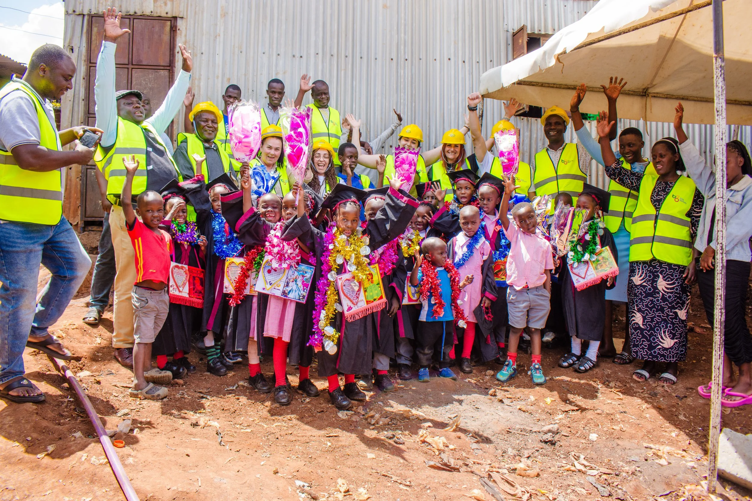 Group of children and adults celebrating the beginning of construction, due to funding recieved by The Boo Charity.